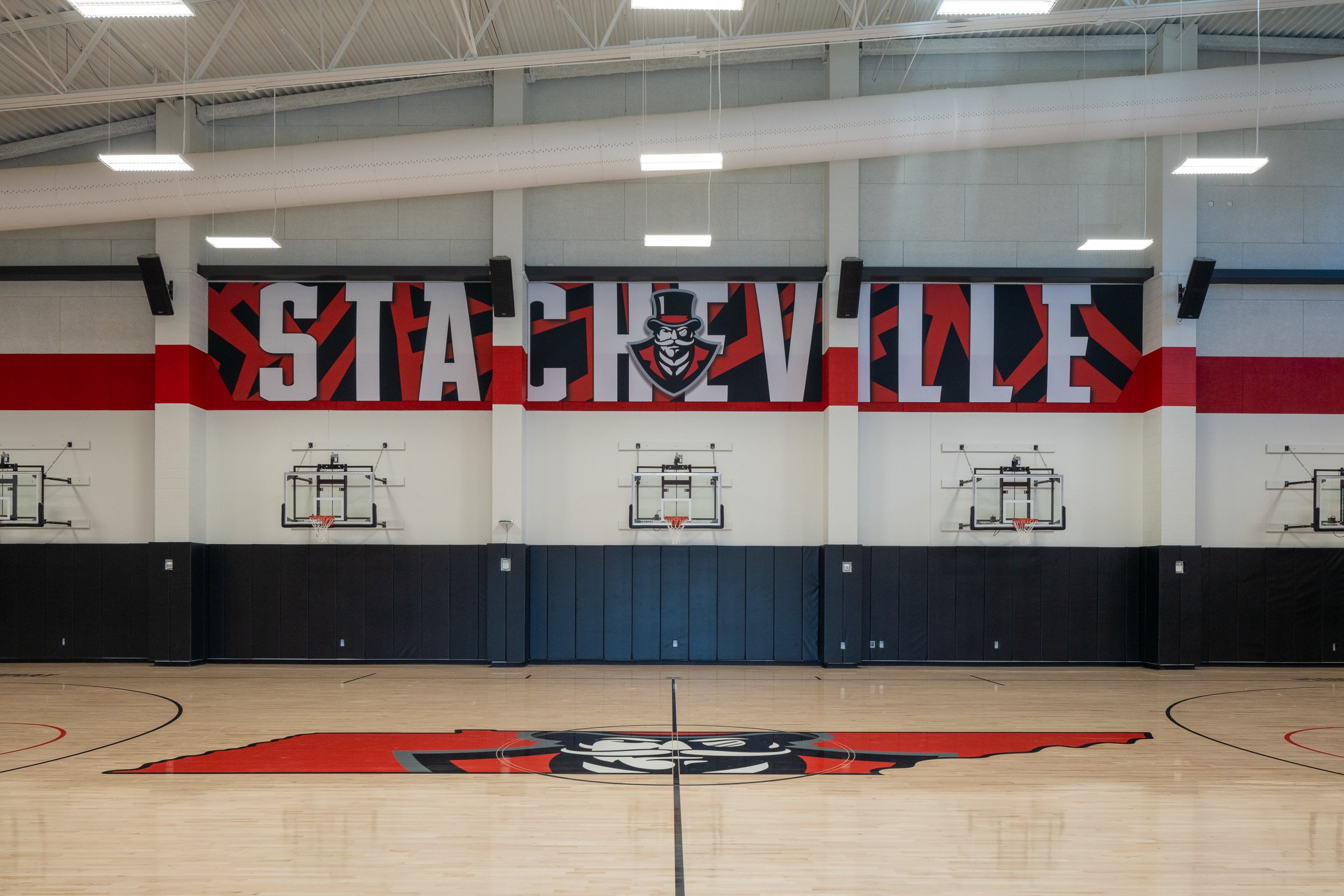 Gymnasium walls featuring bold murals and team colors.