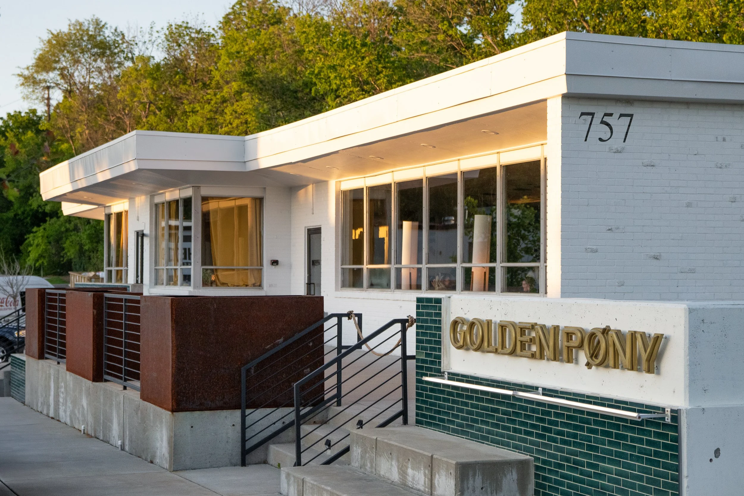 Golden Pony bar exterior with glowing signage and modern architecture.