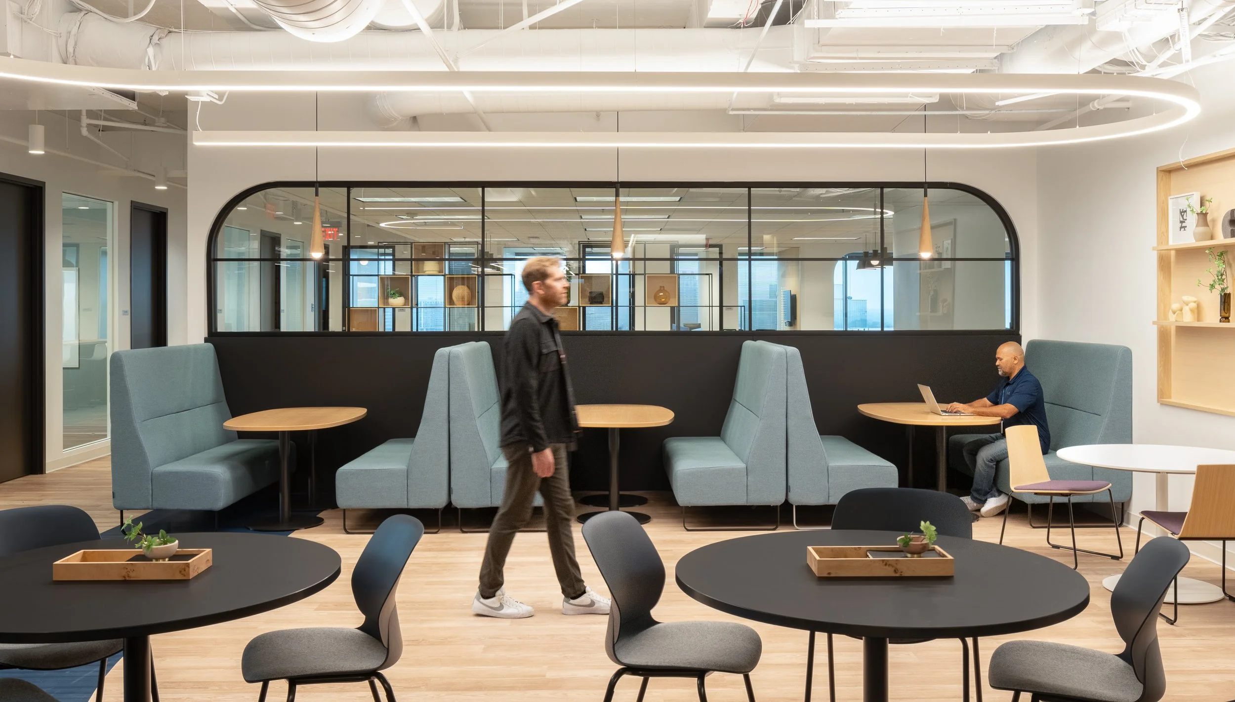 Office dining area with modern booths and pendant lighting.