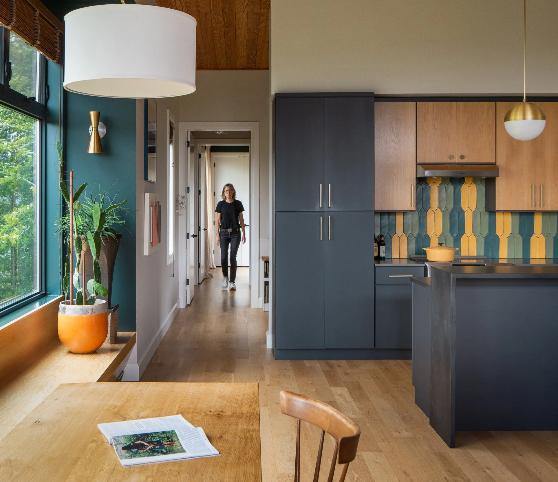 Open kitchen with dark cabinetry and a warm wood interior.