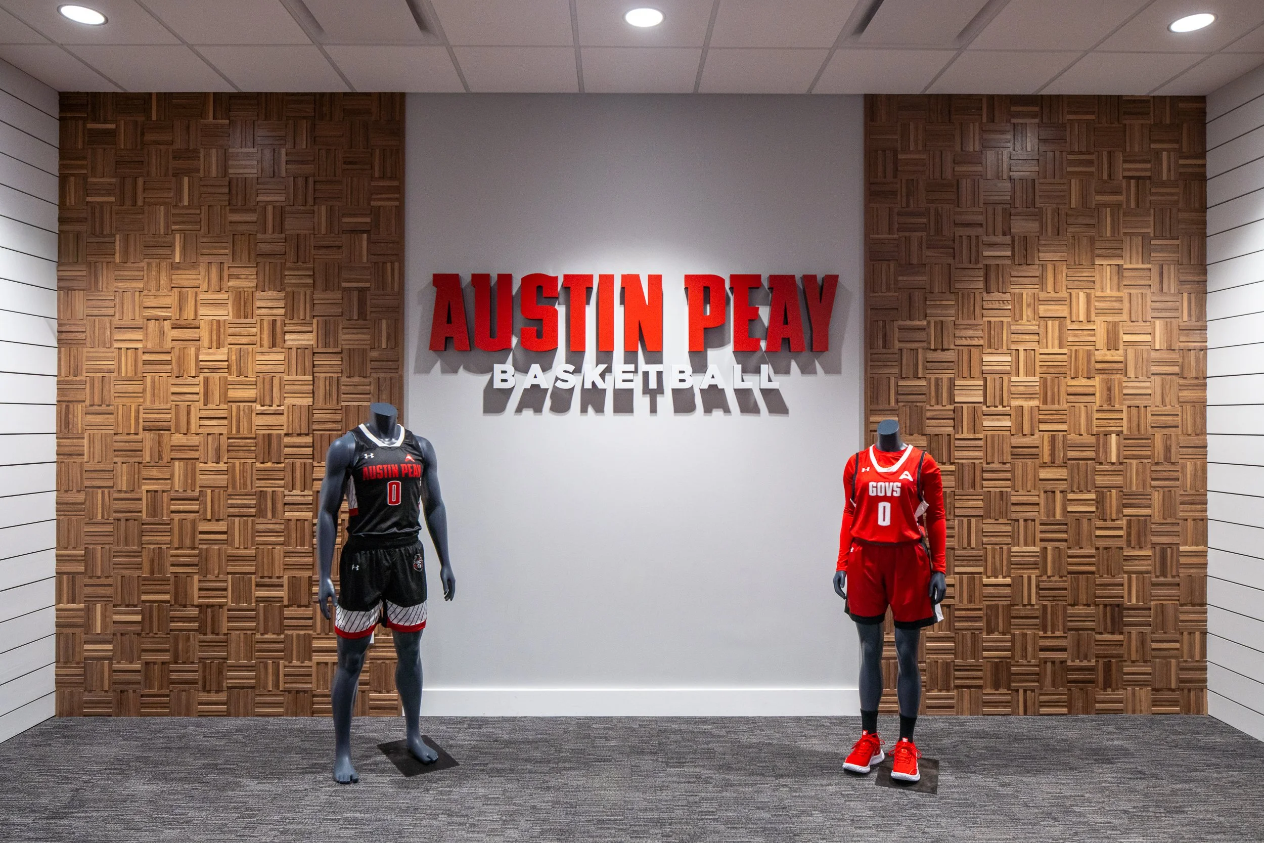 Basketball uniform display featuring mannequins in team jerseys.