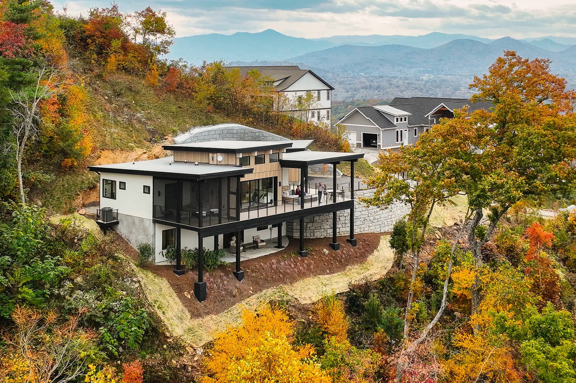 Aerial drone view of a Red Tree Builders home at the Asheville Parade of Homes with mountain views
