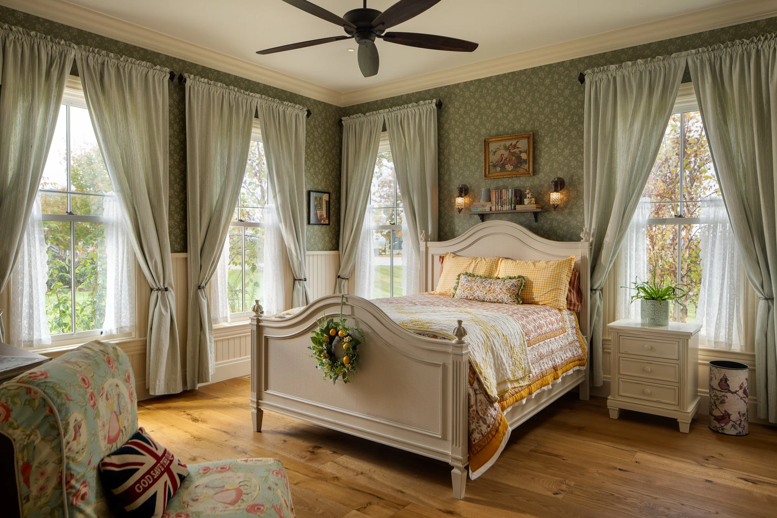 Traditional bedroom with floral wallpaper and garden-facing windows in Hendersonville, NC
