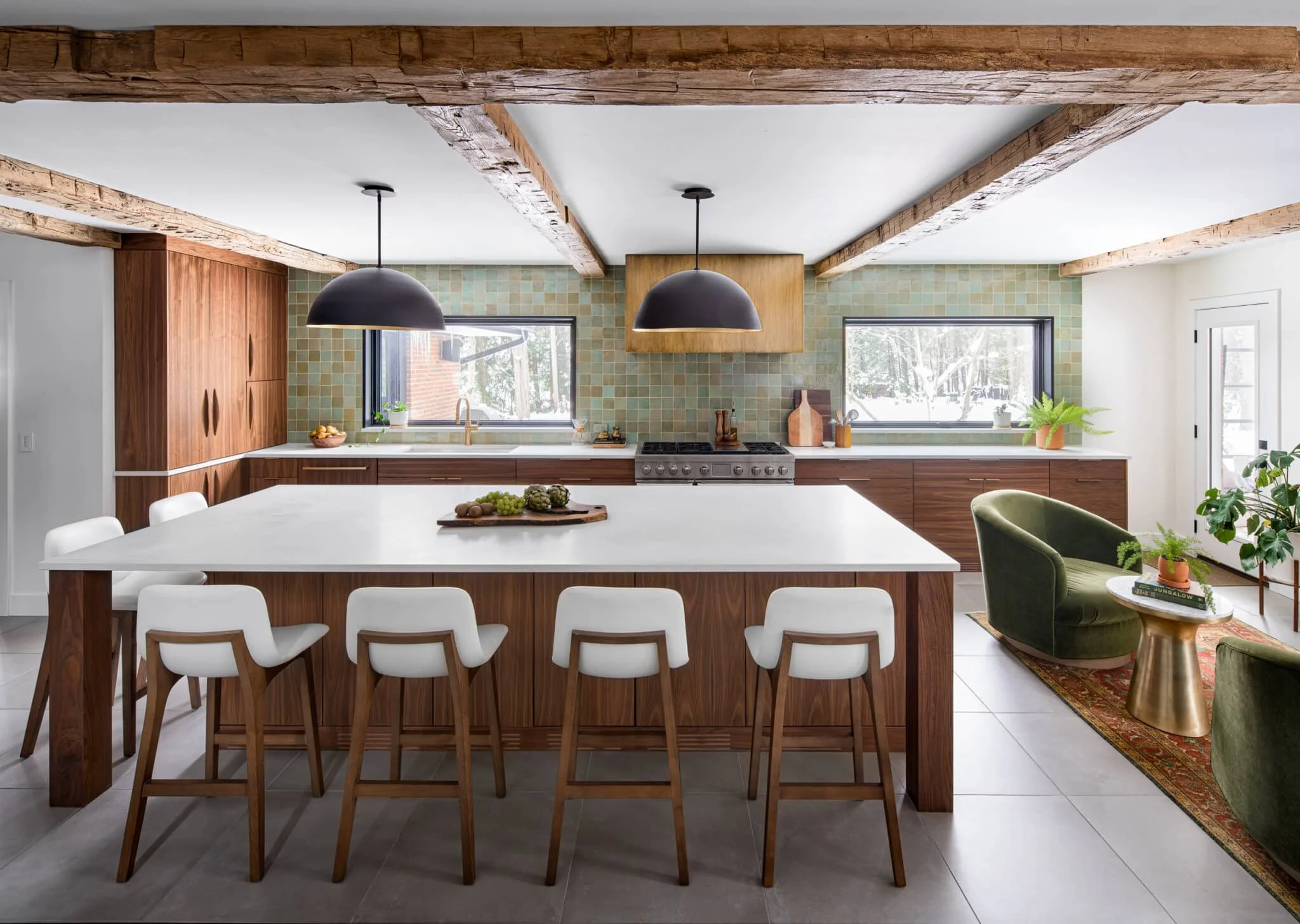 Modern kitchen with walnut cabinetry, exposed ceiling beams, green tile backsplash, and a white island in Toledo, Ohio