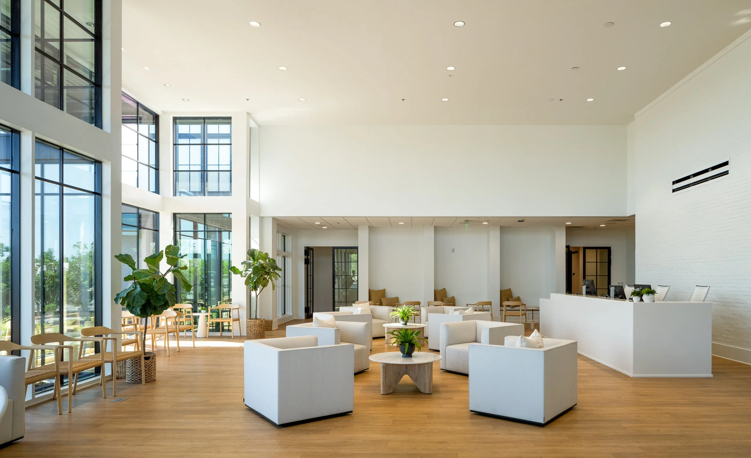 Modern lobby with glass walls and natural lighting.