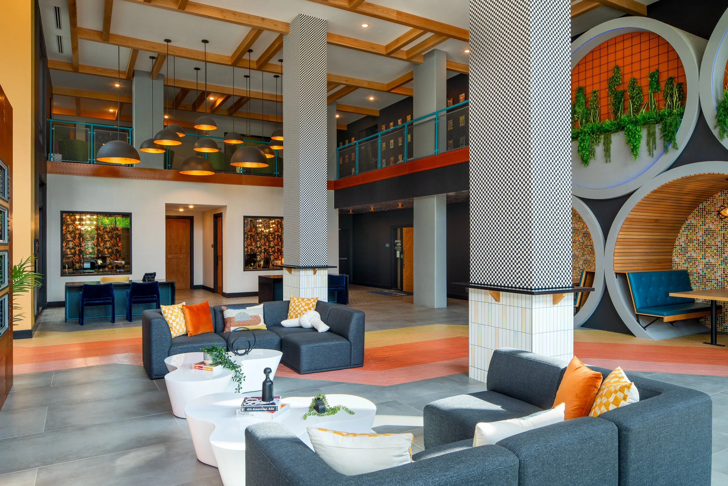 Lobby with bold design elements, checkered columns, and barrel seating.