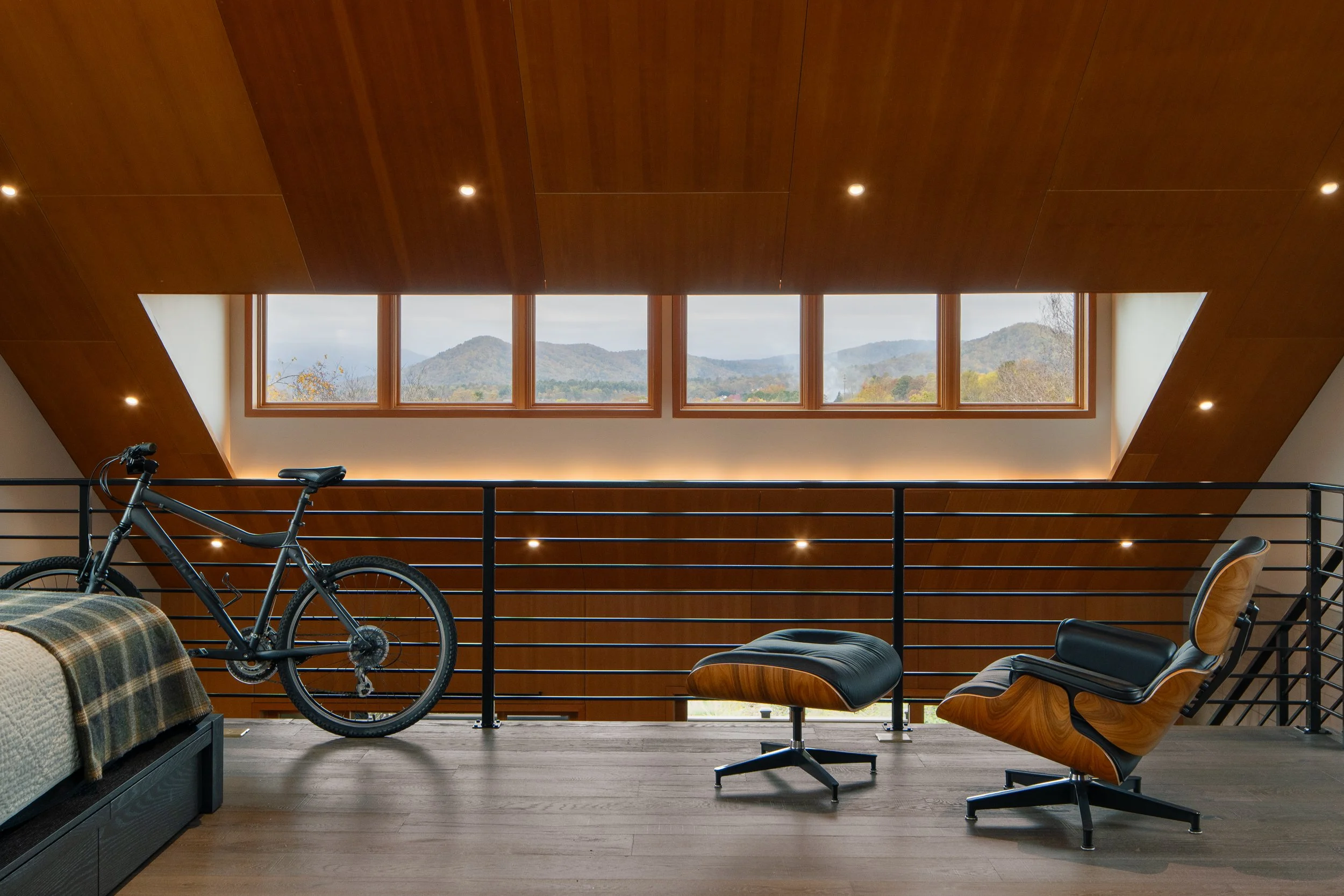 Modern guest house loft with black railing and ridge views in Hendersonville, NC