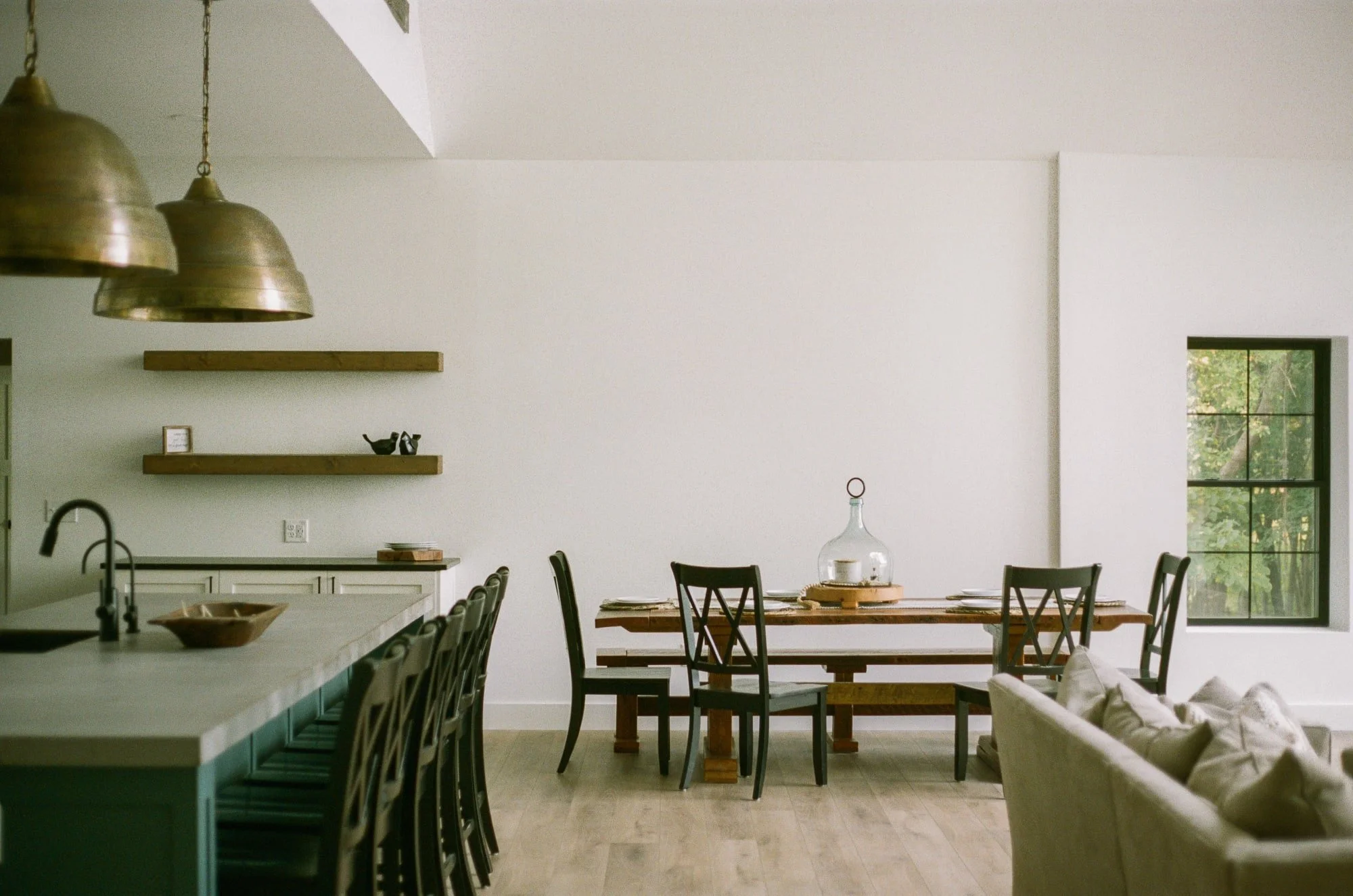 Open kitchen and dining room photographed on 35mm film, warm tones characteristic of Kodak Portra 400