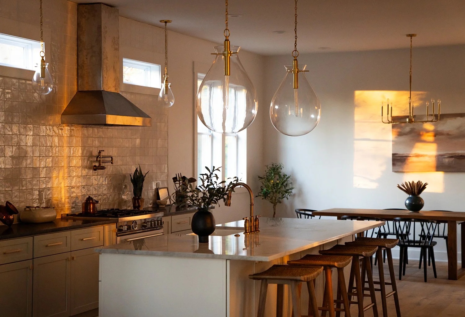 Dining room with large island and golden lighting.