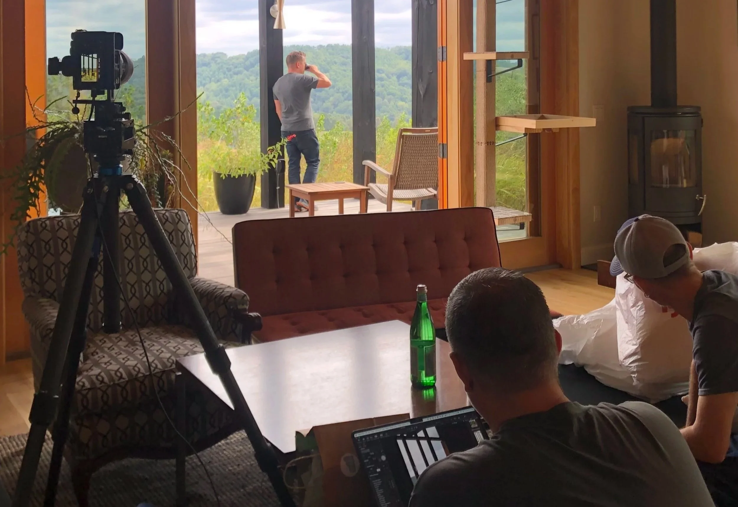 Architectural photographer composing a shot with the architects in a home overlooking the mountains.