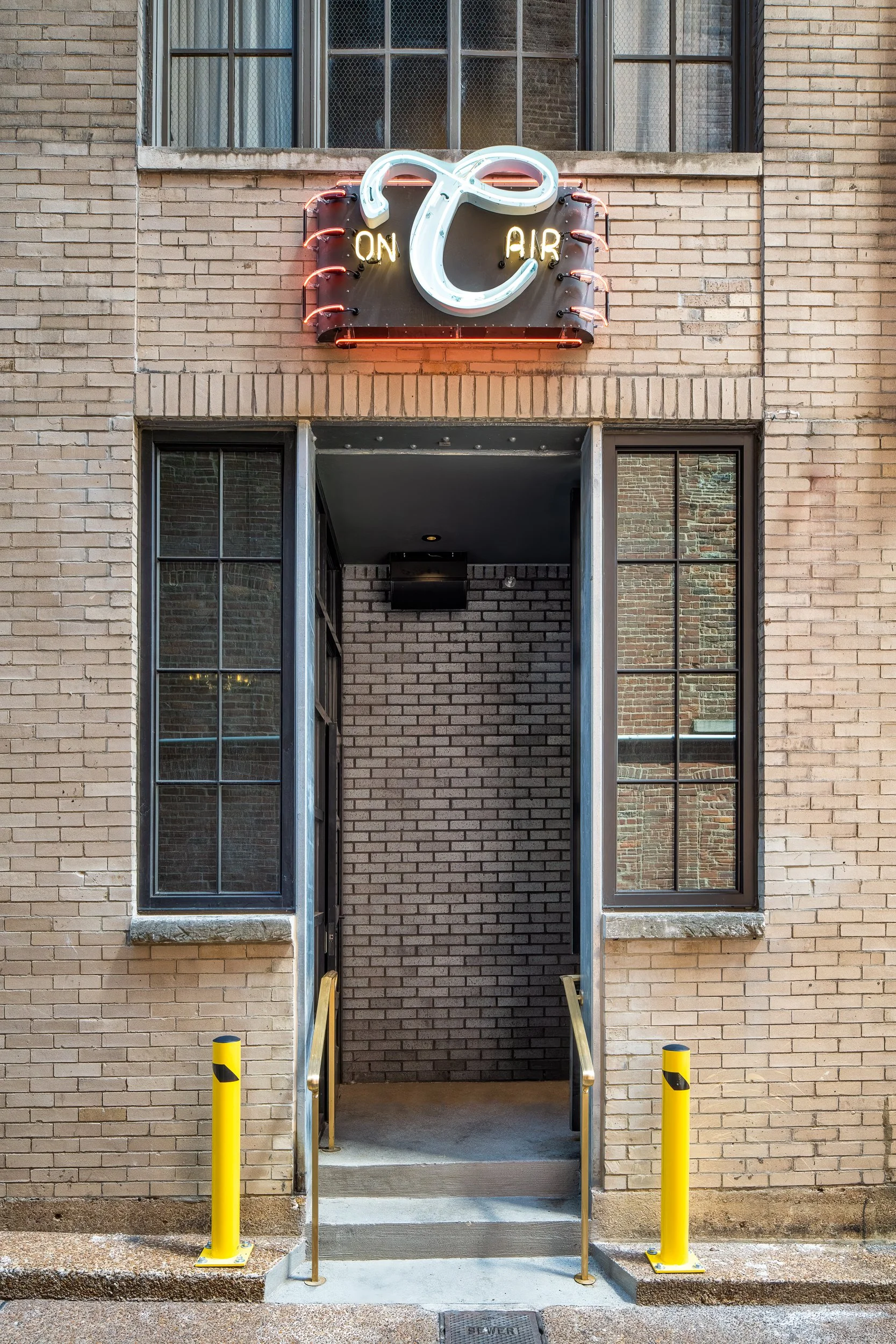 Retro-inspired hotel alley entry on Printers Alley in downtown Nashville with neon signage and moody evening light