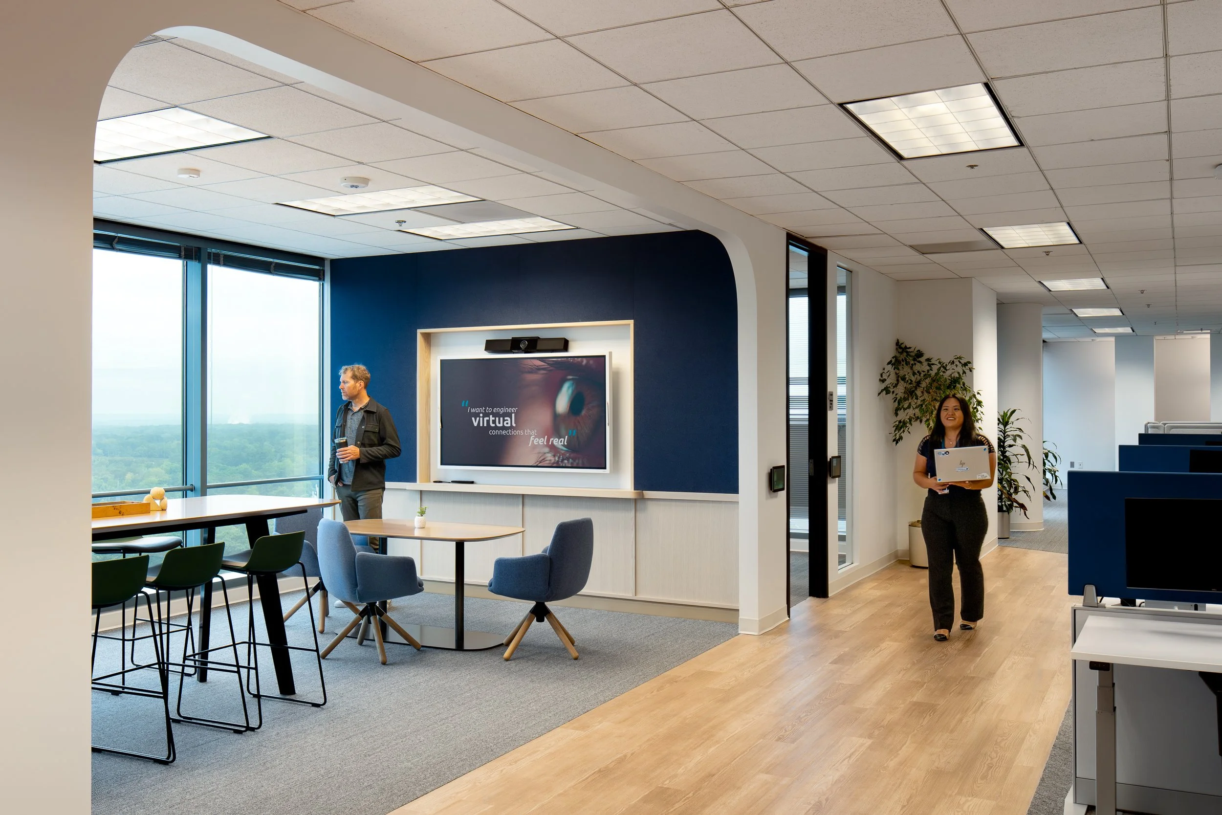 Small meeting space with a bright blue accent wall and chairs.