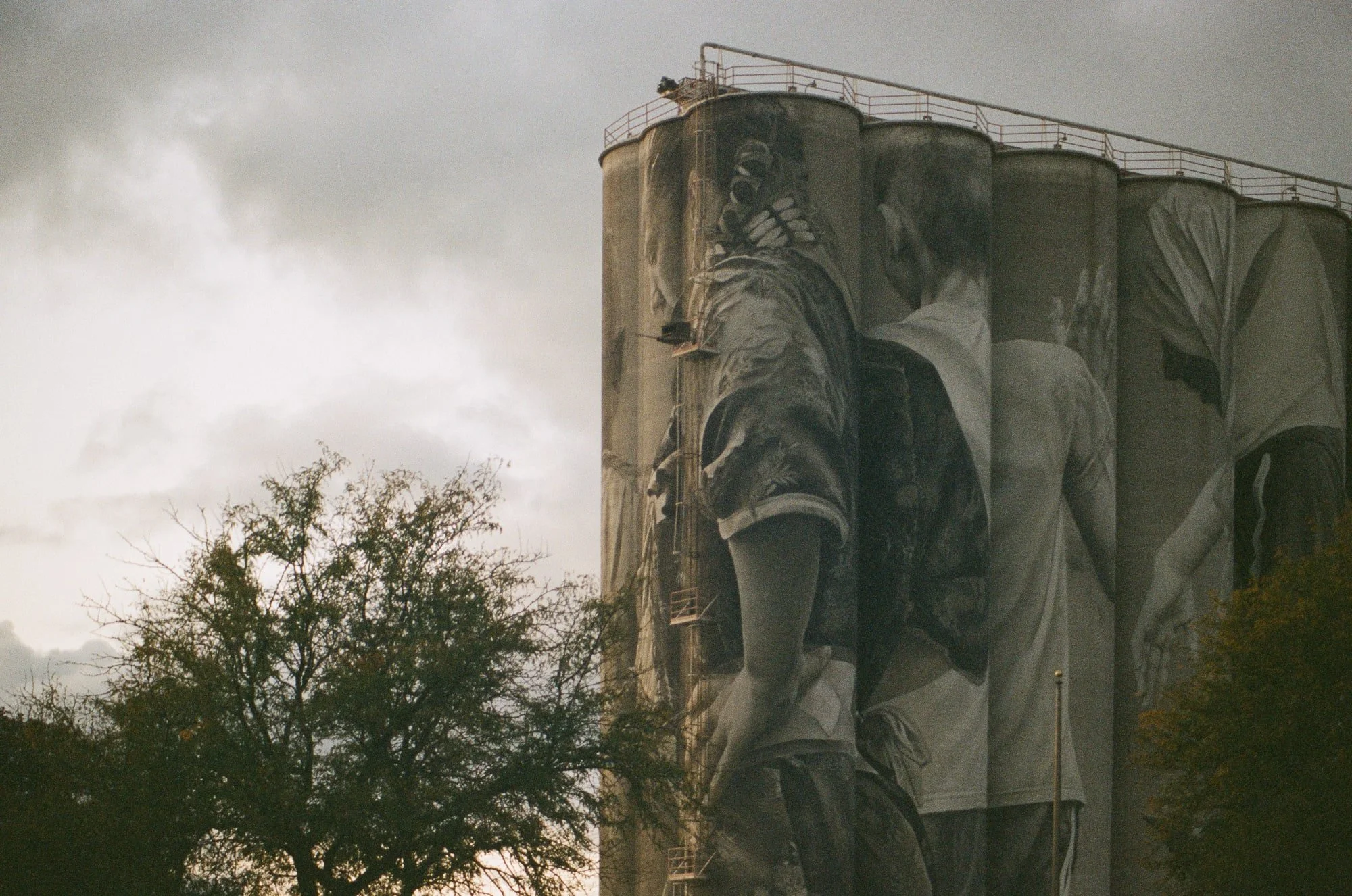 Grain silo with a painted mural photographed on expired Kodak Portra 400 film