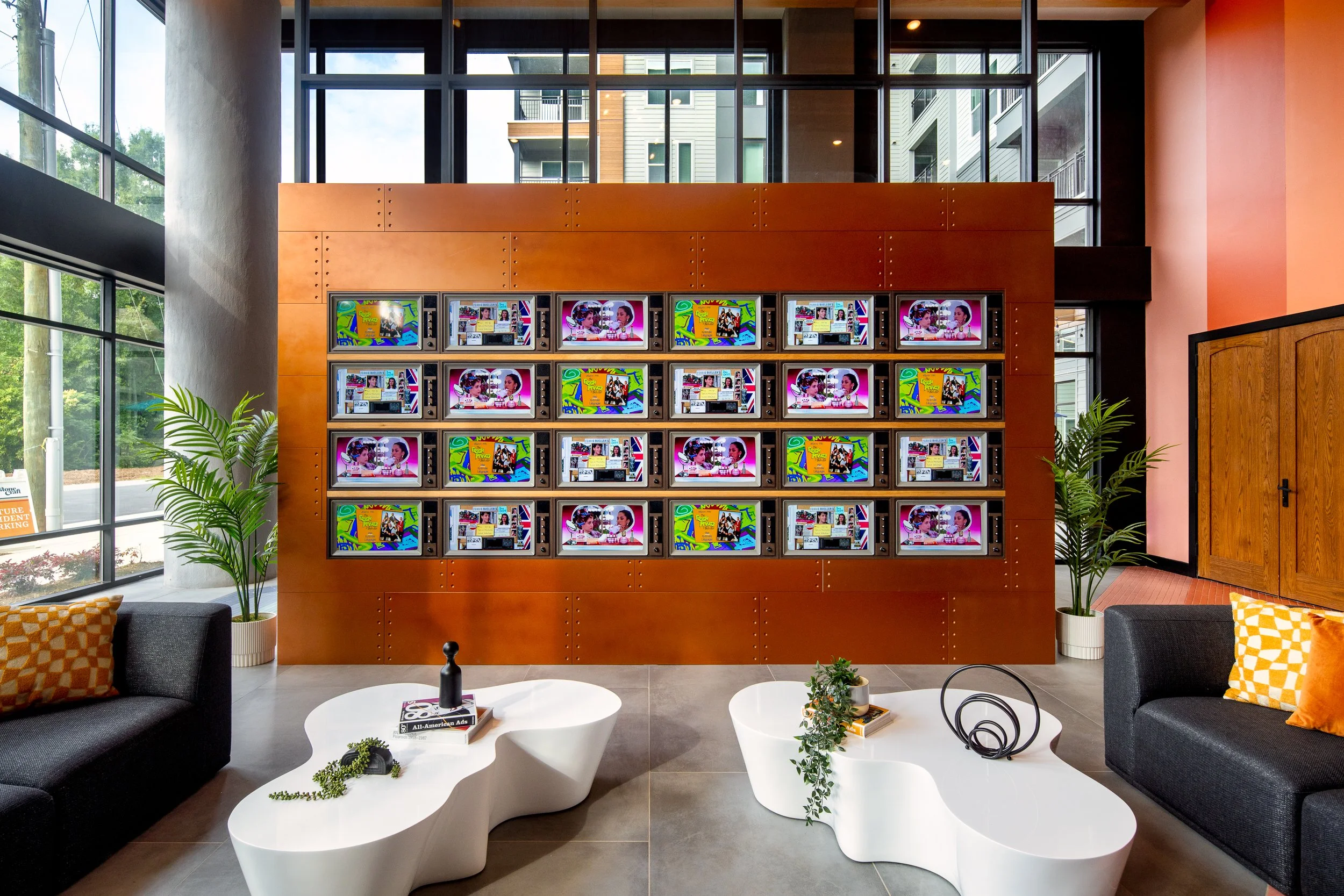 Lobby TV wall with 80s-inspired visual content.