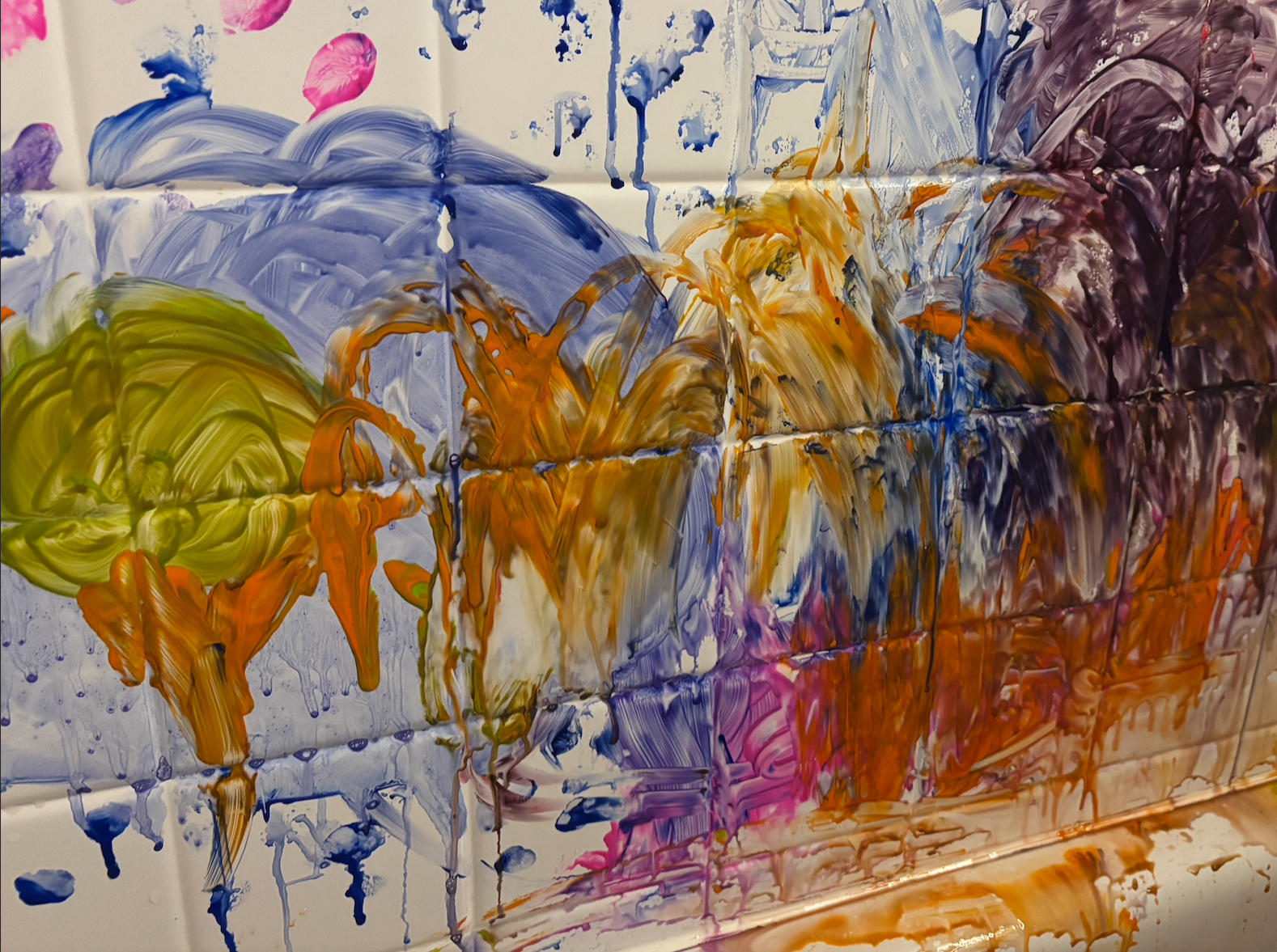 Abstract painting with colorful brushstrokes in purple, orange, yellow, pink, and white on a white tiled surface.