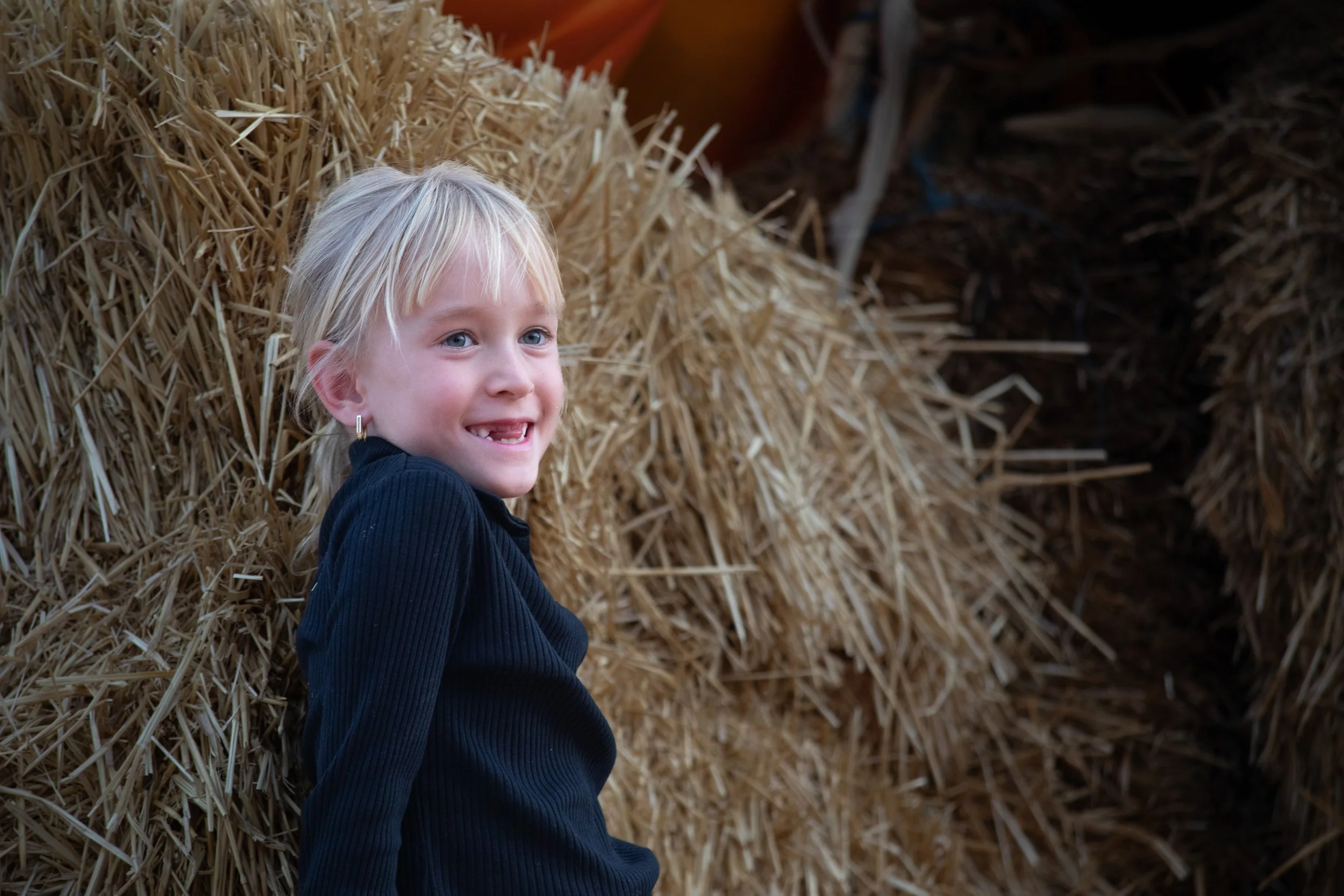 Simple and sweet: a black turtleneck, a Halloween patch, and a radiant smile