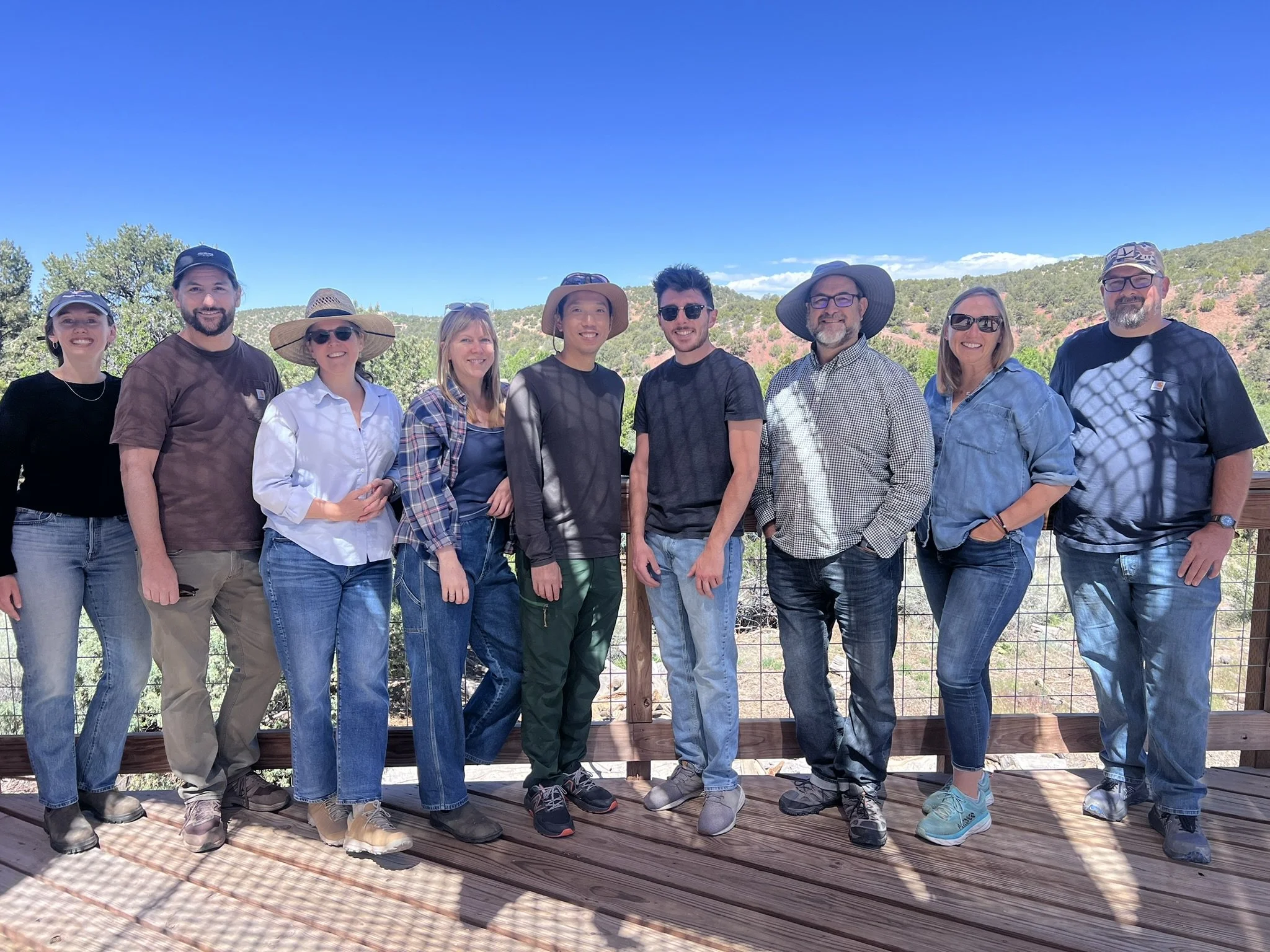 9 members of anthropopulus posing outside
