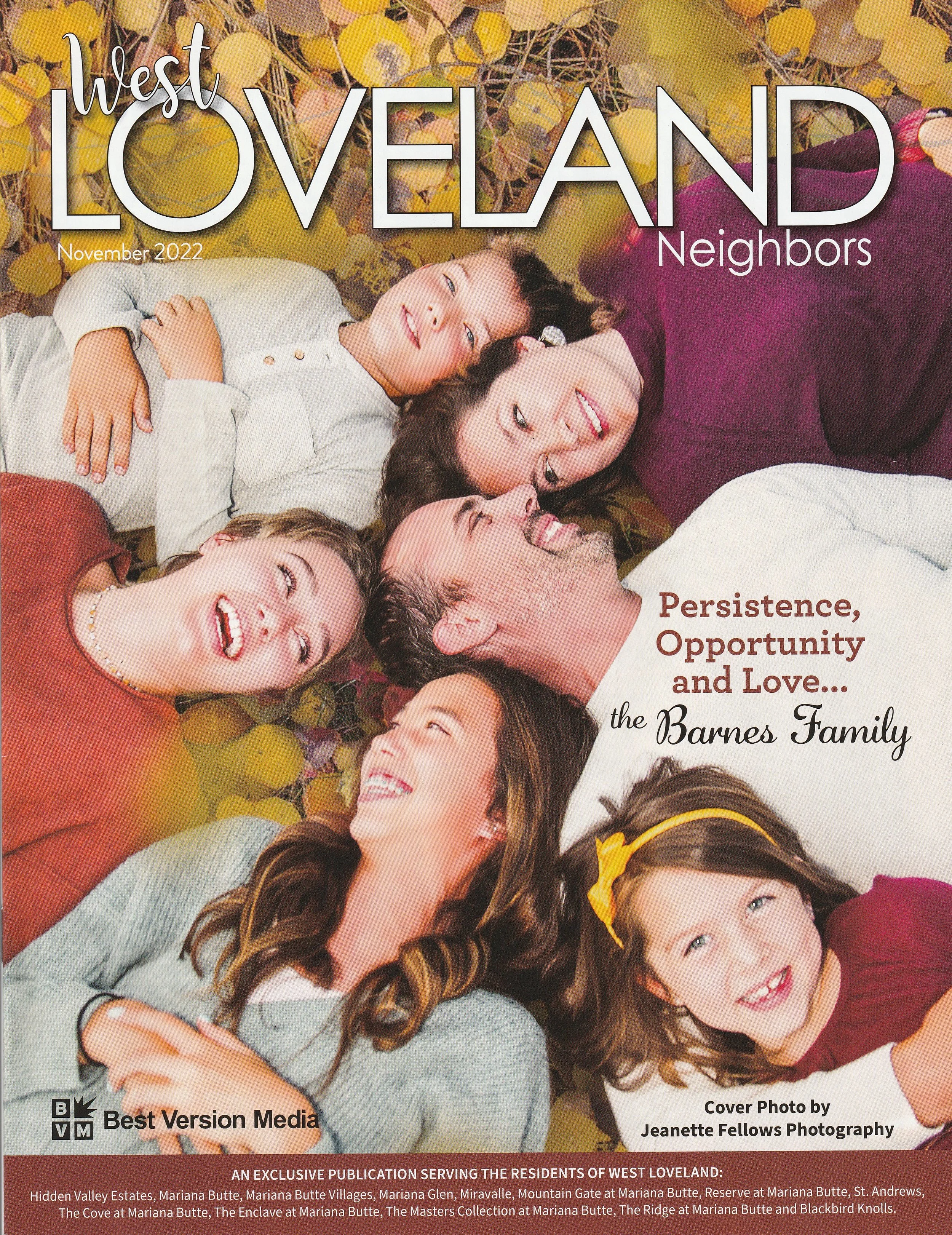 Cover of West Loveland Neighbors magazine featuring a family of six lying on the ground outdoors among yellow aspen fall leaves, smiling and looking at each other. Jeanette Fellows Photography www.fellows.photos