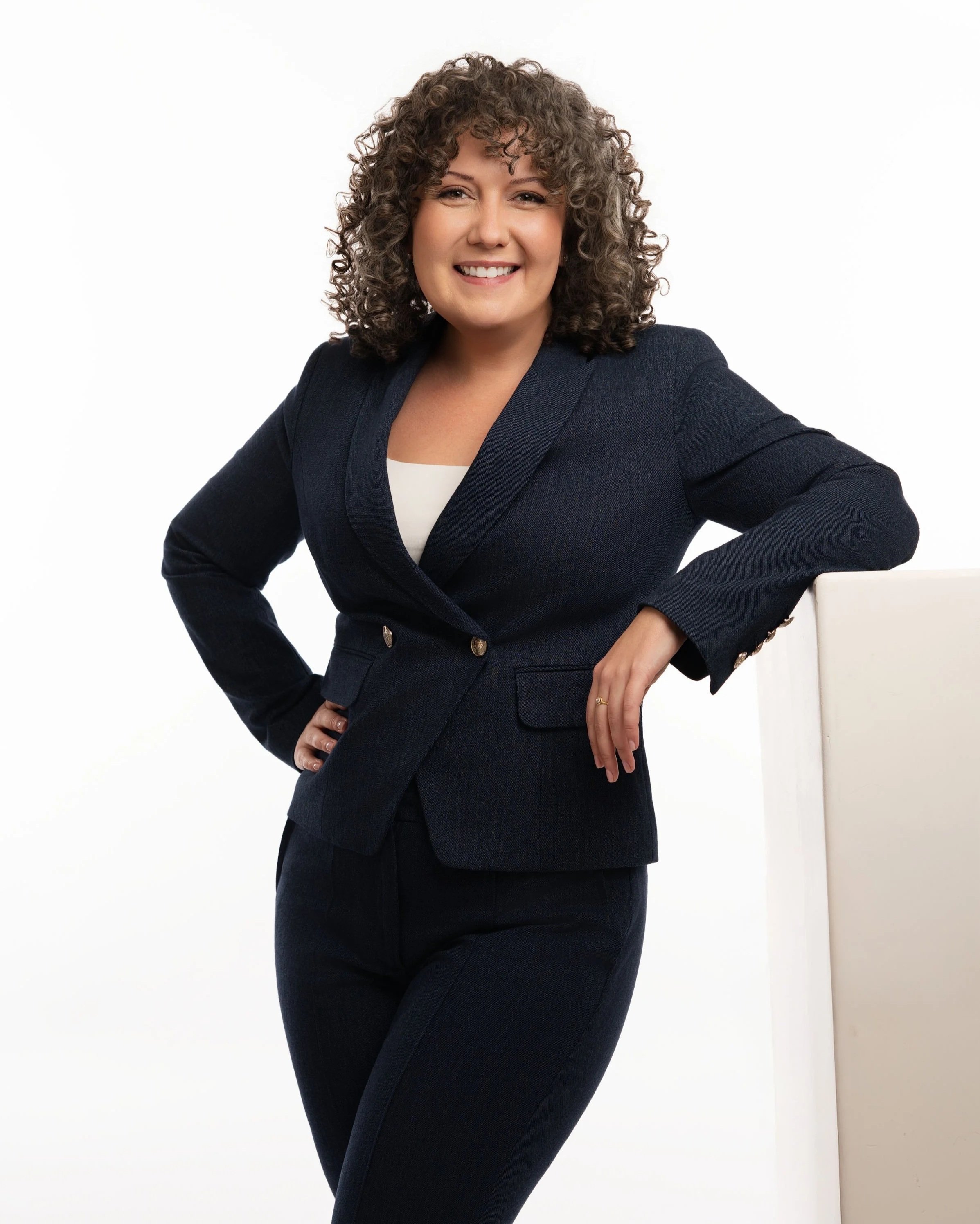 Kristina St. Cyr, divorce coach for working moms preparing for divorce, smiling in professional navy blazer