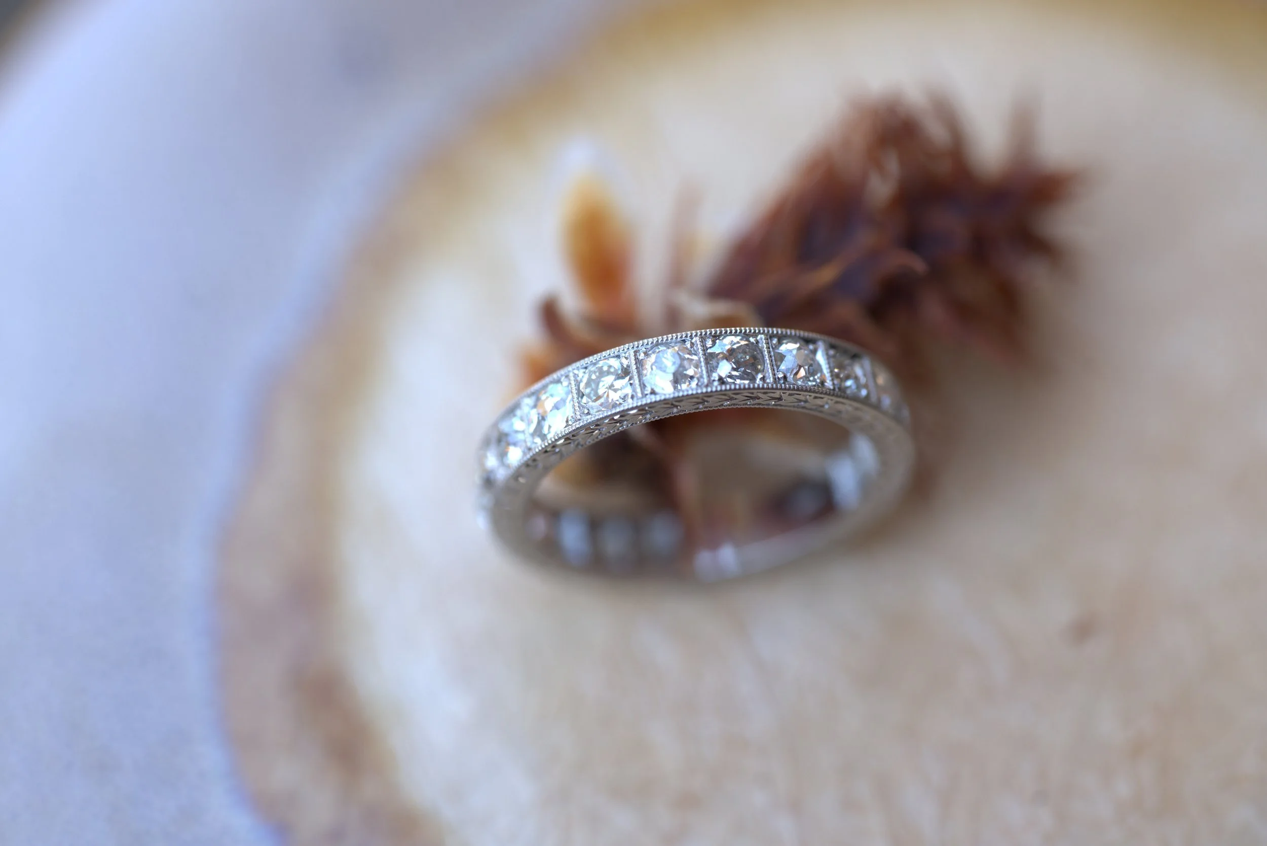 Platinum Eternity band with old-cut round diamonds and wheat pattern engraving on the side