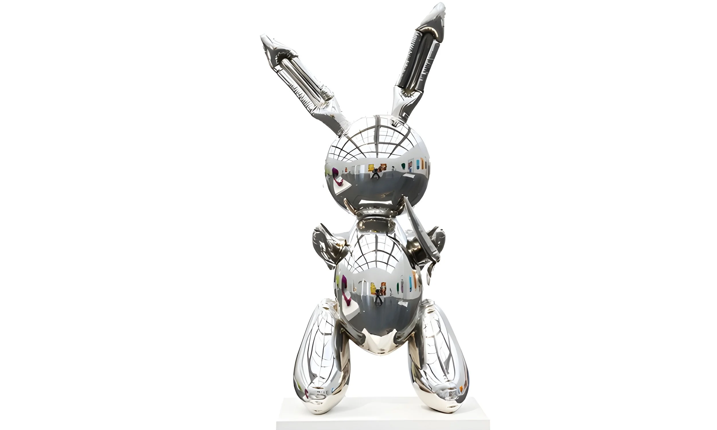A shiny, reflective silver sculpture of a rabbit with upright ears, standing on its hind legs, with a mirror-like surface that shows the room and photographer in its reflection.