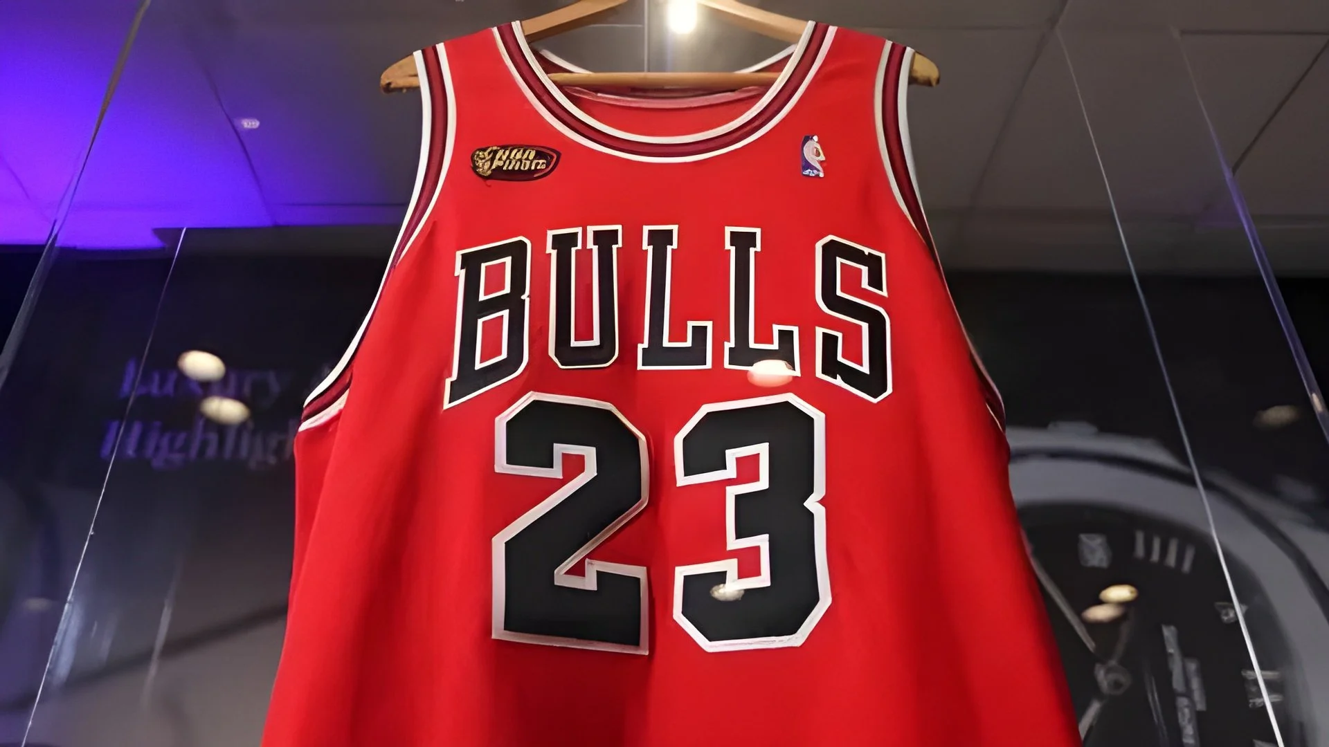 A red Chicago Bulls basketball jersey with the number 23 displayed, featuring black and white lettering and details.