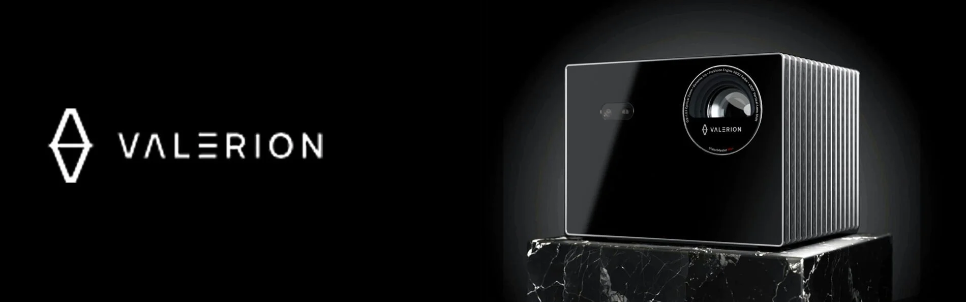 A black camera with a large lens, branded Valeron, resting on a black marble pedestal against a black background.