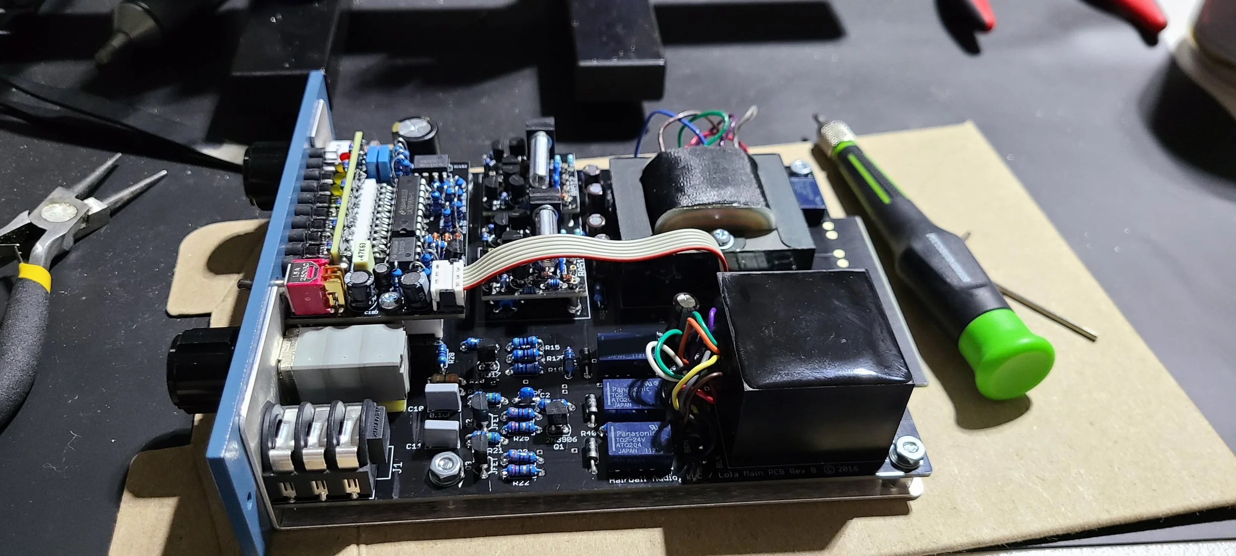 Close-up of precision soldering on a printed circuit board for a custom analog audio gear build.