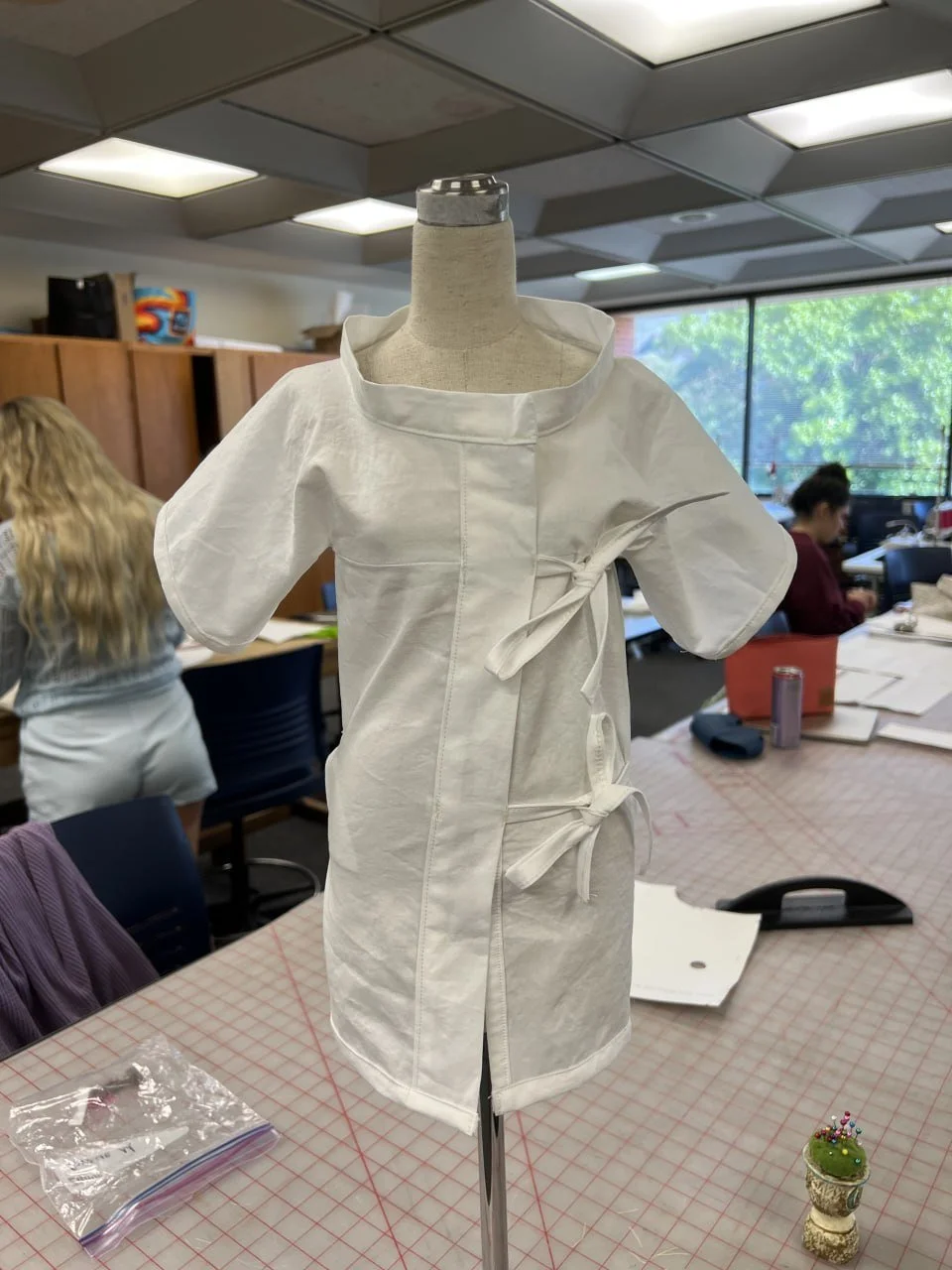 White half-scale development garment made before the larger finished zero-waste dress.