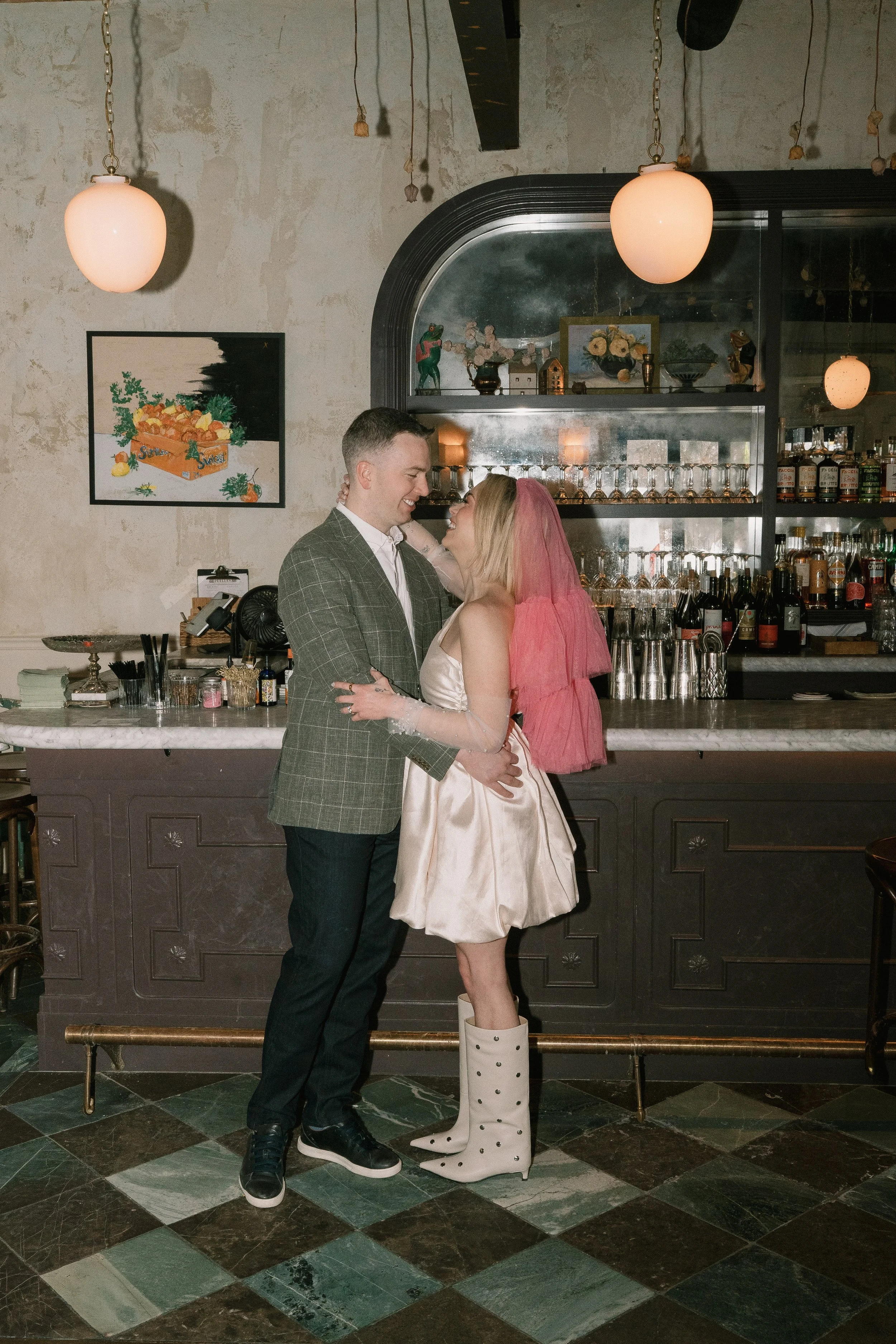couple embracing in a Boston bar, photographed with direct flash, wearing vintage, retro outfits