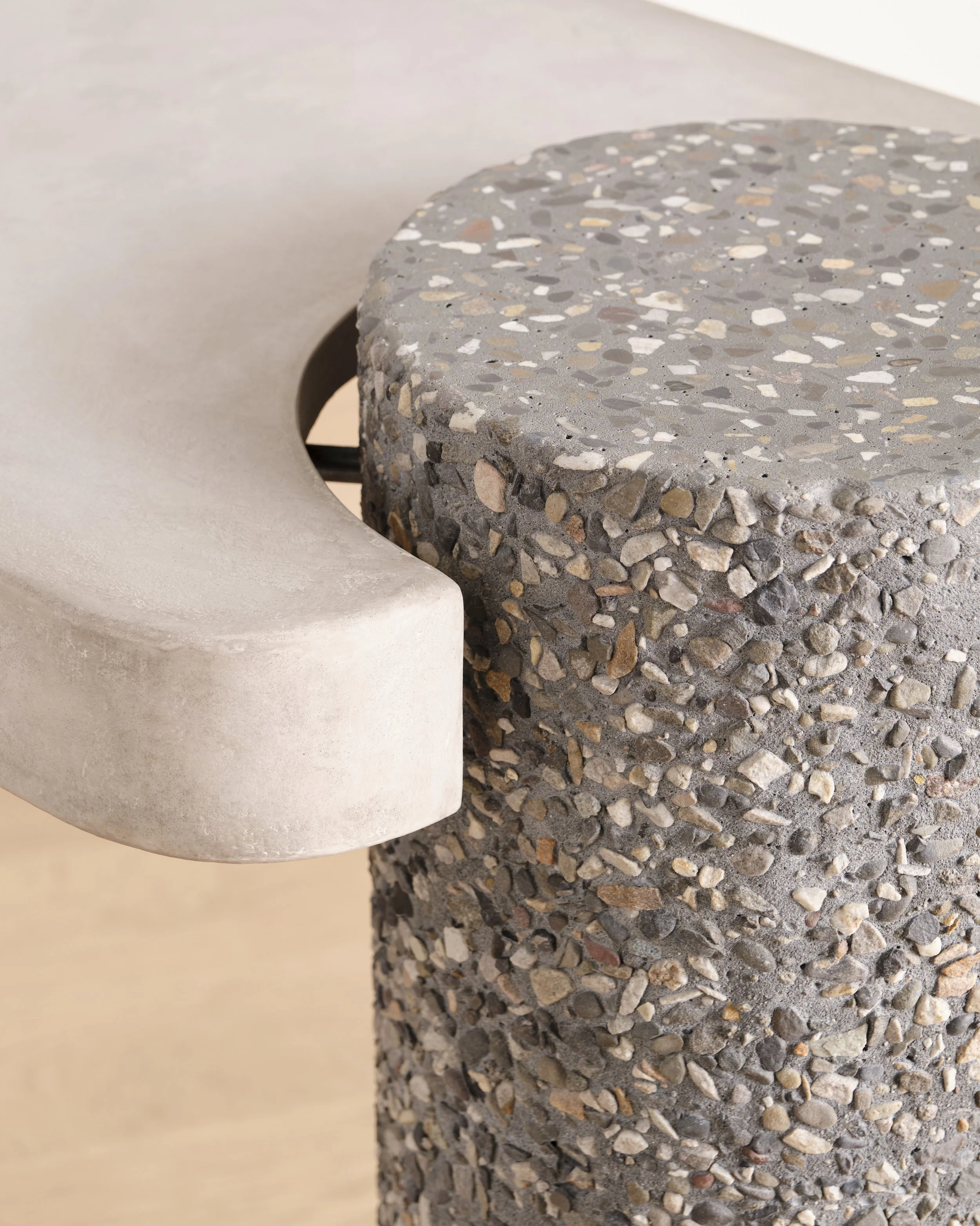 Detail of Pebbles Entry Table's hand-sculpted top and pebble-textured column leg 