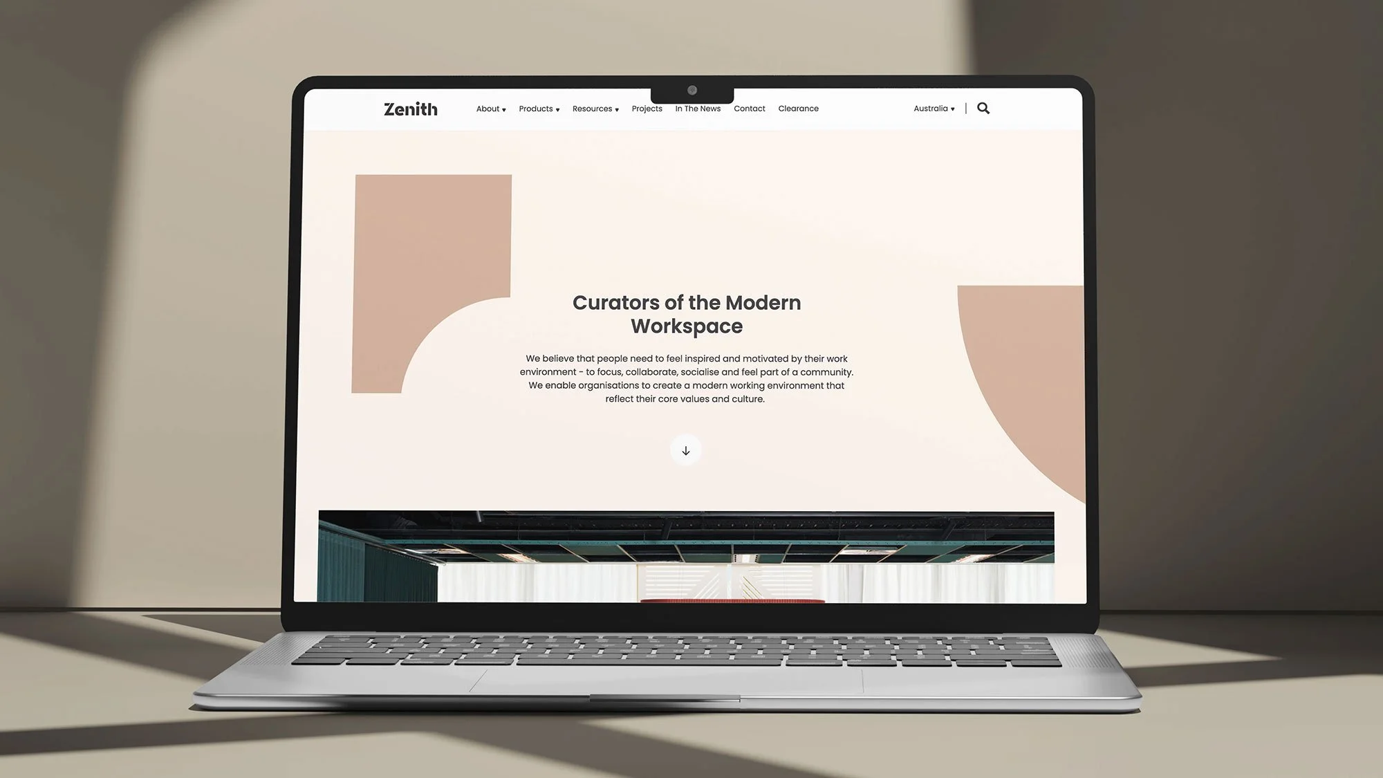 Laptop displaying a webpage with the title 'Curators of the Modern Workspace' and abstract shapes. The page includes navigation links like 'About,' 'Products,' 'Resources,' 'Projects,' and more.