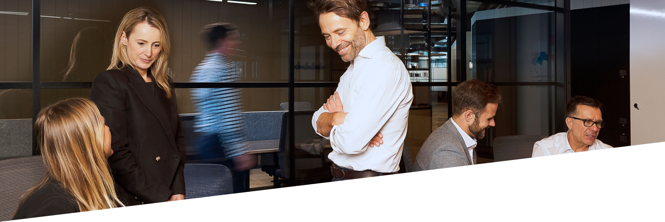 Office setting with people having a conversation