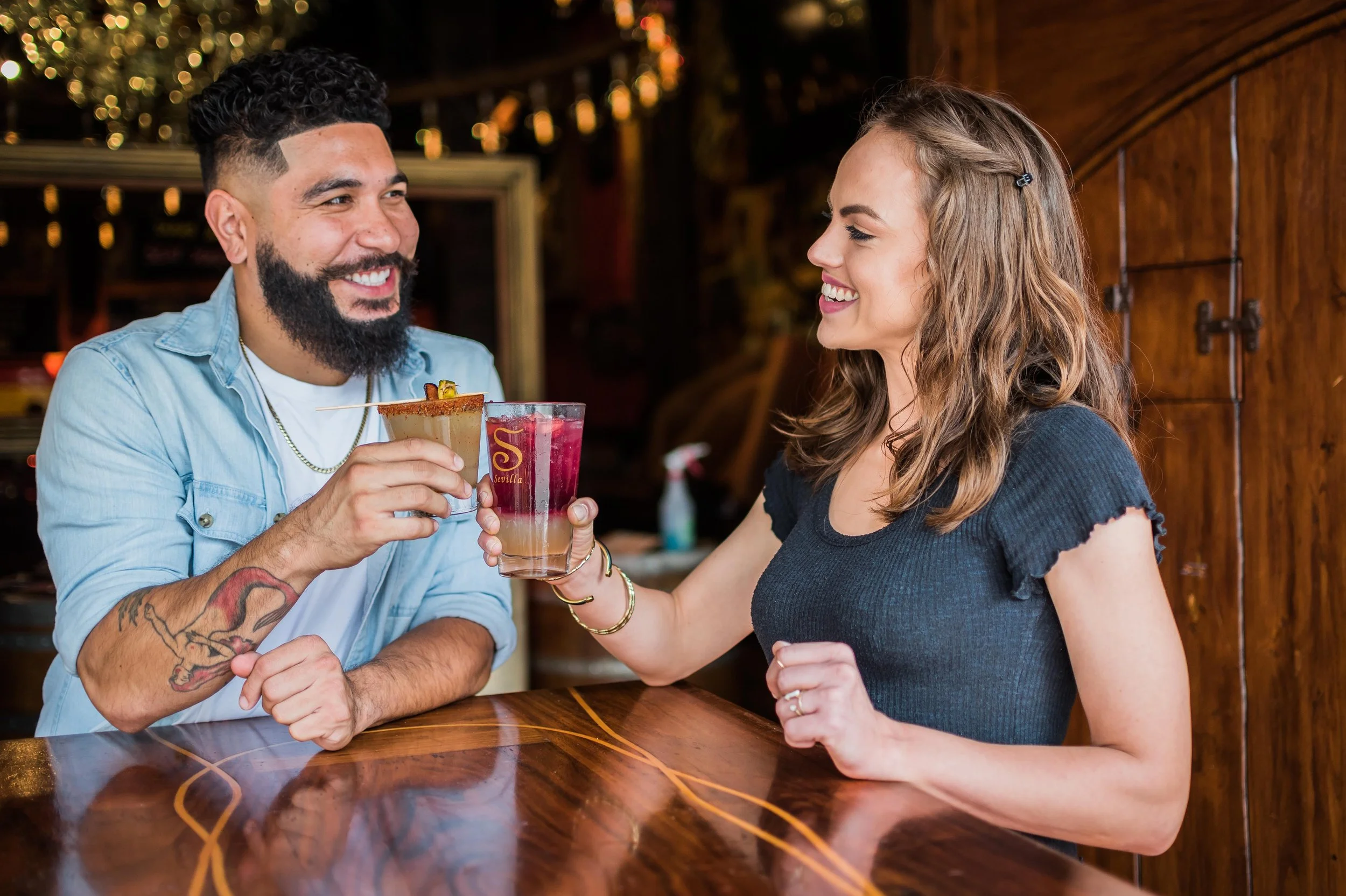Man and Woman toasting drinks at Cafe Sevilla