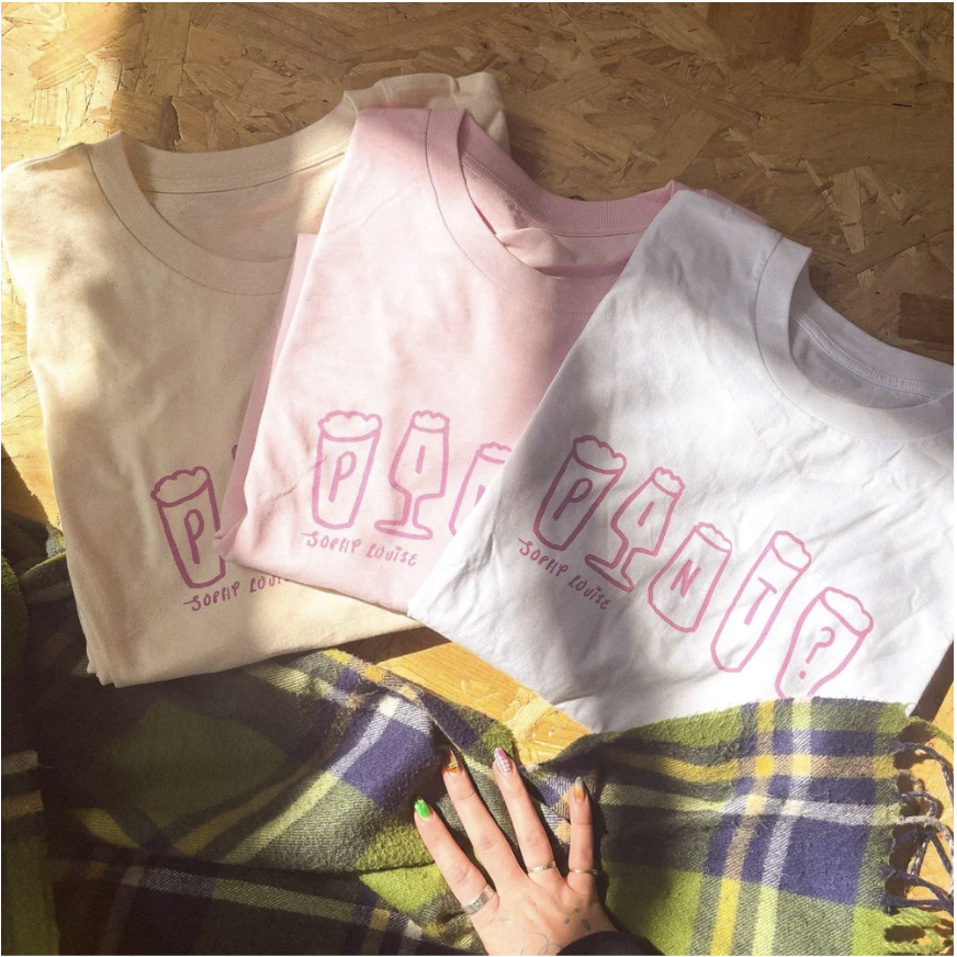 A pink notebook with a spiral binding.