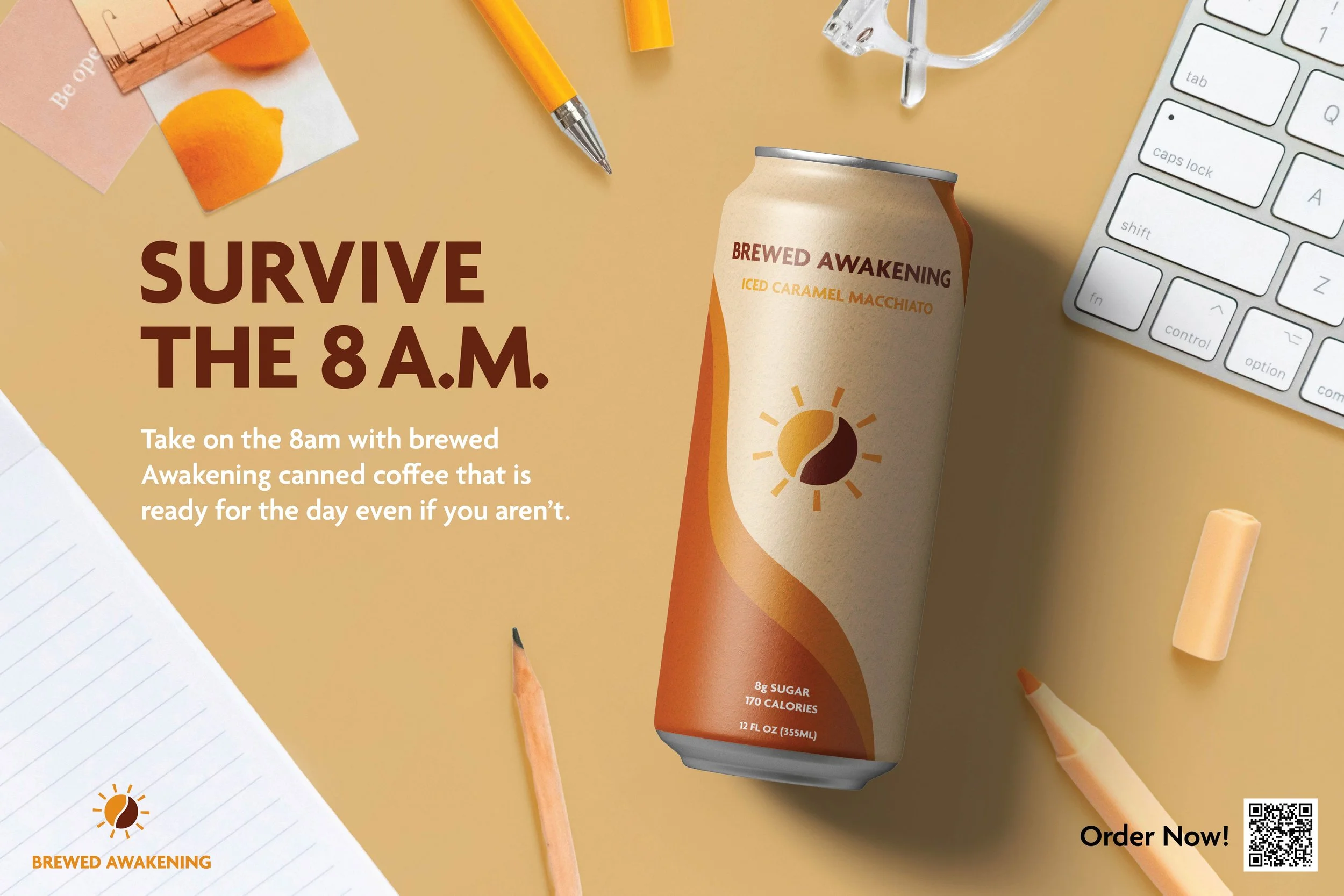 An advertisement for brewed awakening canned coffee, featuring a beige can with orange and brown accents, a sun logo, and text indicating it contains iced caramel macchiato, 8 grams of sugar, 170 calories, and 12 fluid ounces. The background includes a white computer keyboard, a yellow pencil, orange chalk, a paper with lined writing, and an orange crayon, set on a light beige surface.