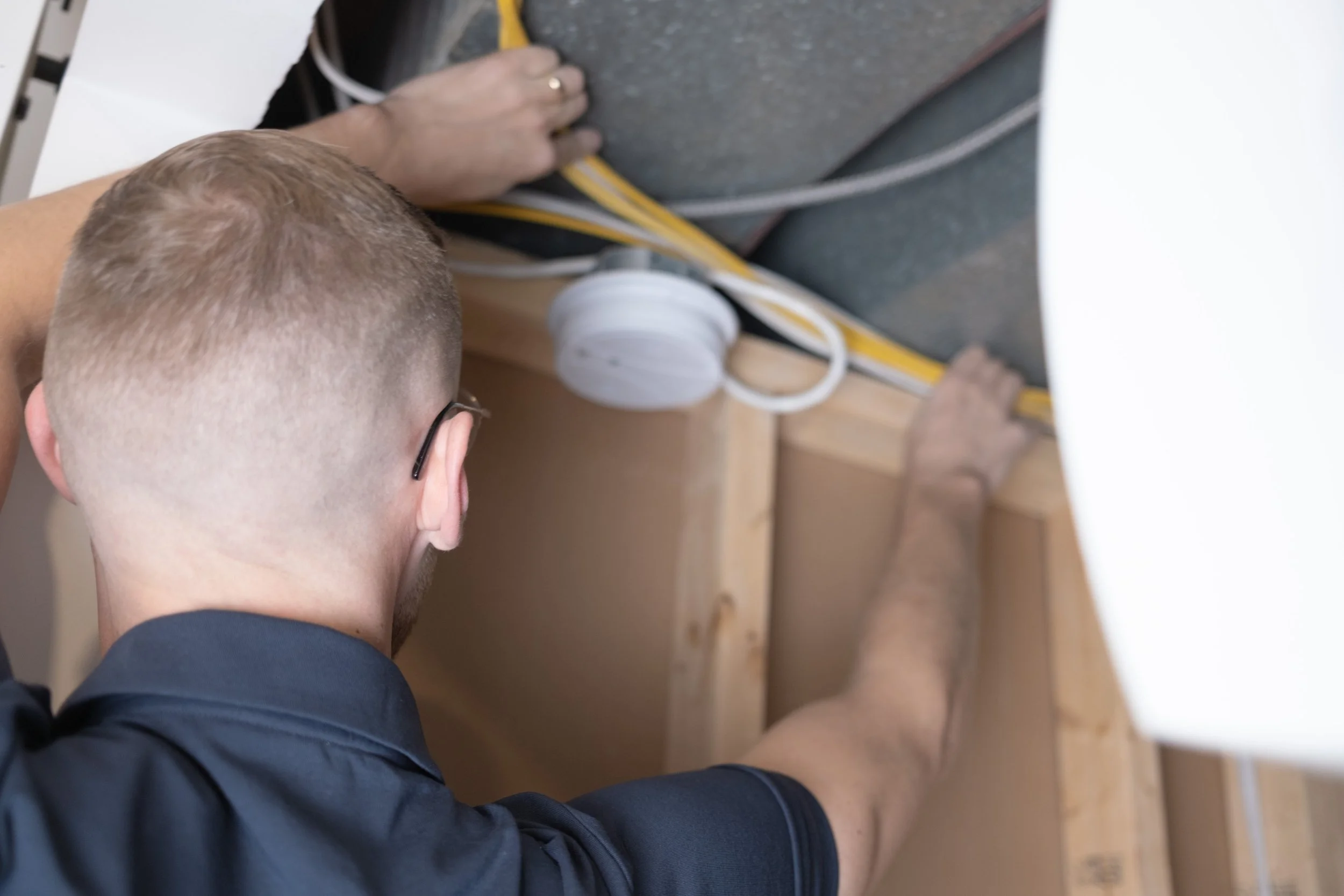 Jesse Tompkins of Fusesmart Electric serving Bragg Creek, AB doing electrical work.