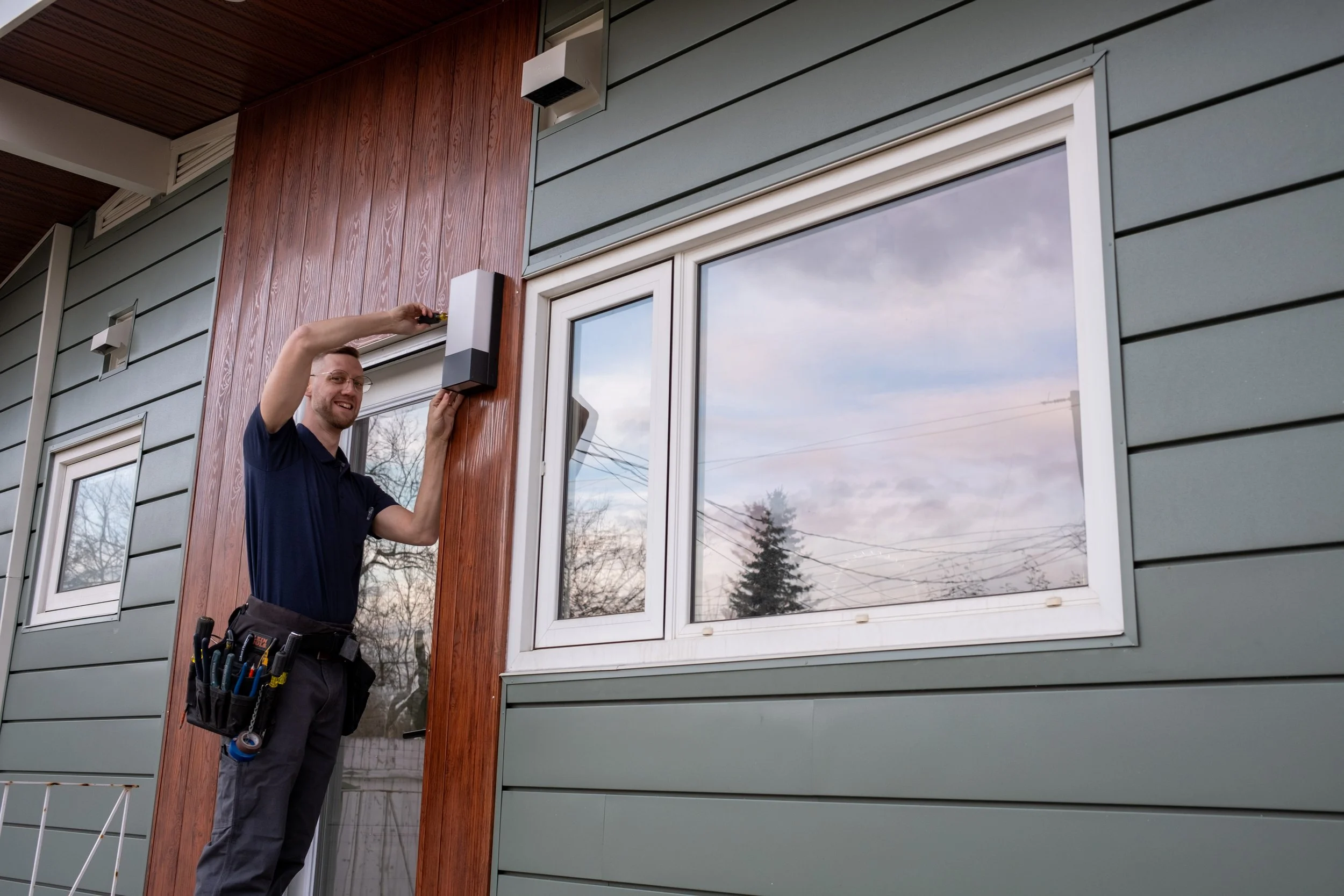 Jesse Tompkins of Fusesmart Electric in High River, Alberta installing exterior lighting.