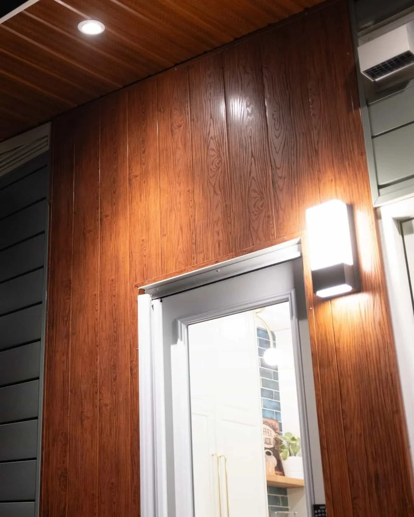 Exterior pot light and outdoor wall sconce installation on the front porch of a Calgary home by FuseSmart Electric.