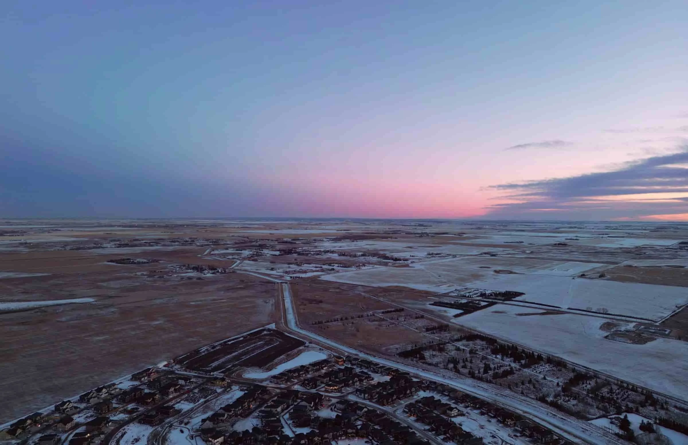 Aerial view of a snow-covered sunset in Chestermere, Alberta.