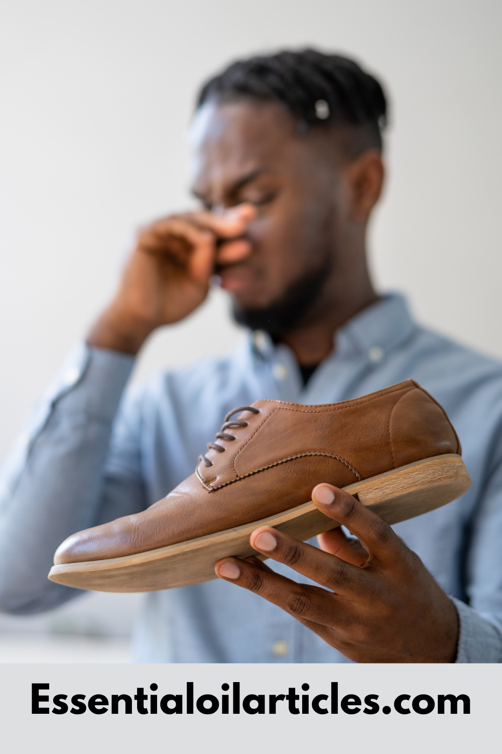 Black man holding nose because shoe smells