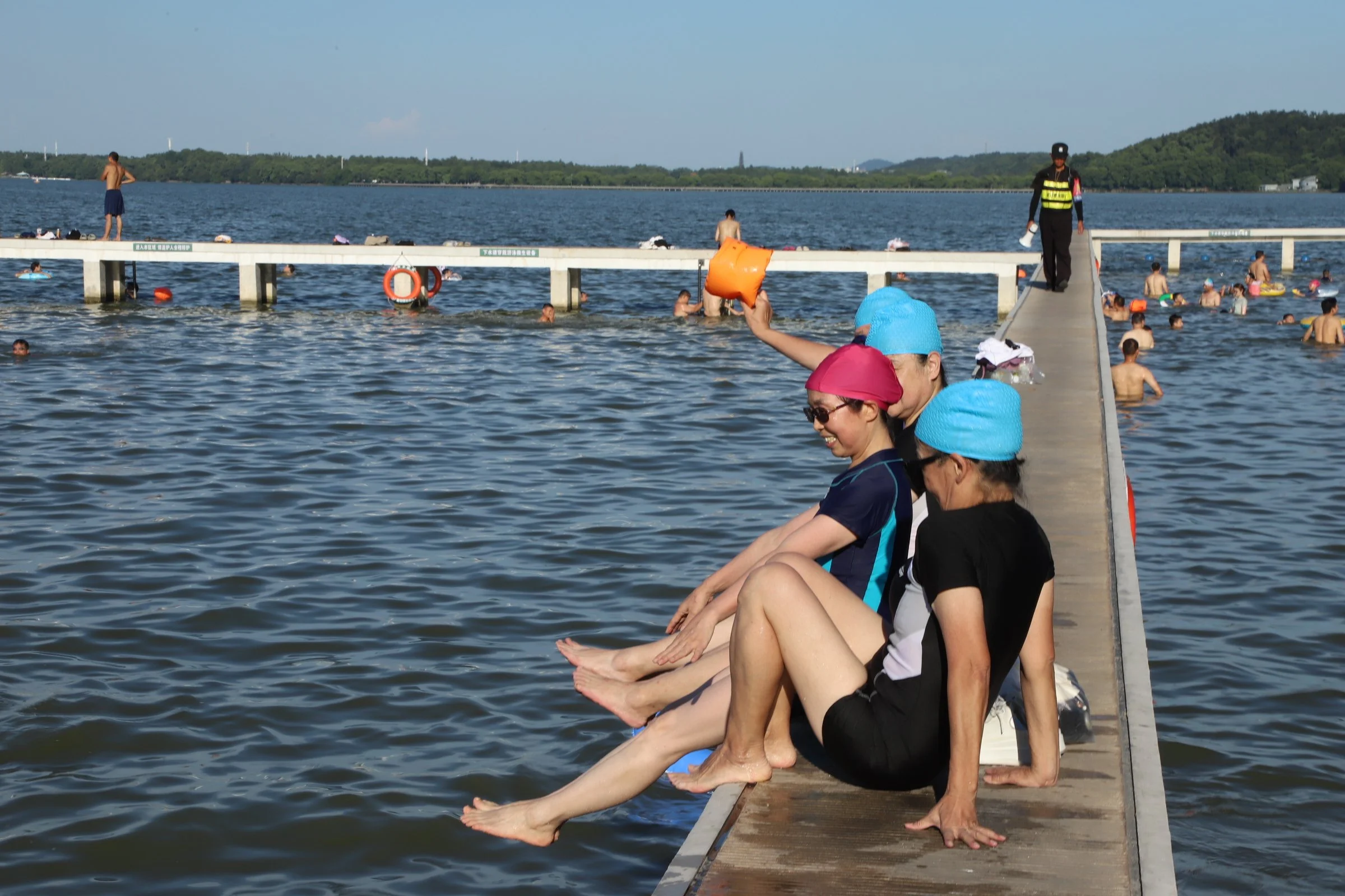 Residents swim or sit at the edge of a pier (my favorite part) at East Lake on July 24, 2025. Photos by Wanqing
