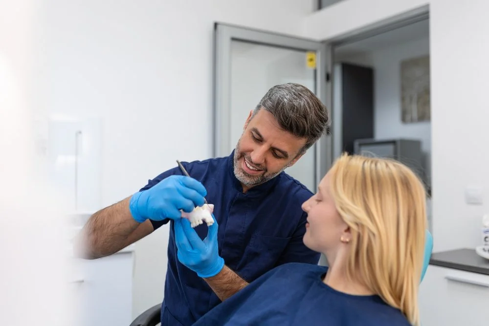 dental bridge and dental implant models comparing options for replacing a missing tooth