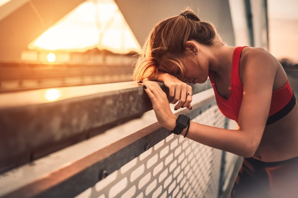 person needing to drink water outdoors to support dry mouth prevention and maintain oral health during hot summer weather