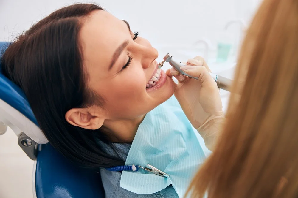 dental hygienist performing scaling and root planing for gum disease treatment