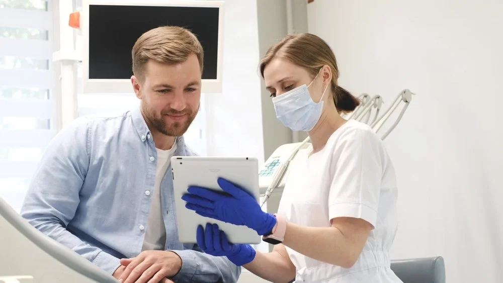 dentist discussing personalized comprehensive dental care plan with patient during dental consultation