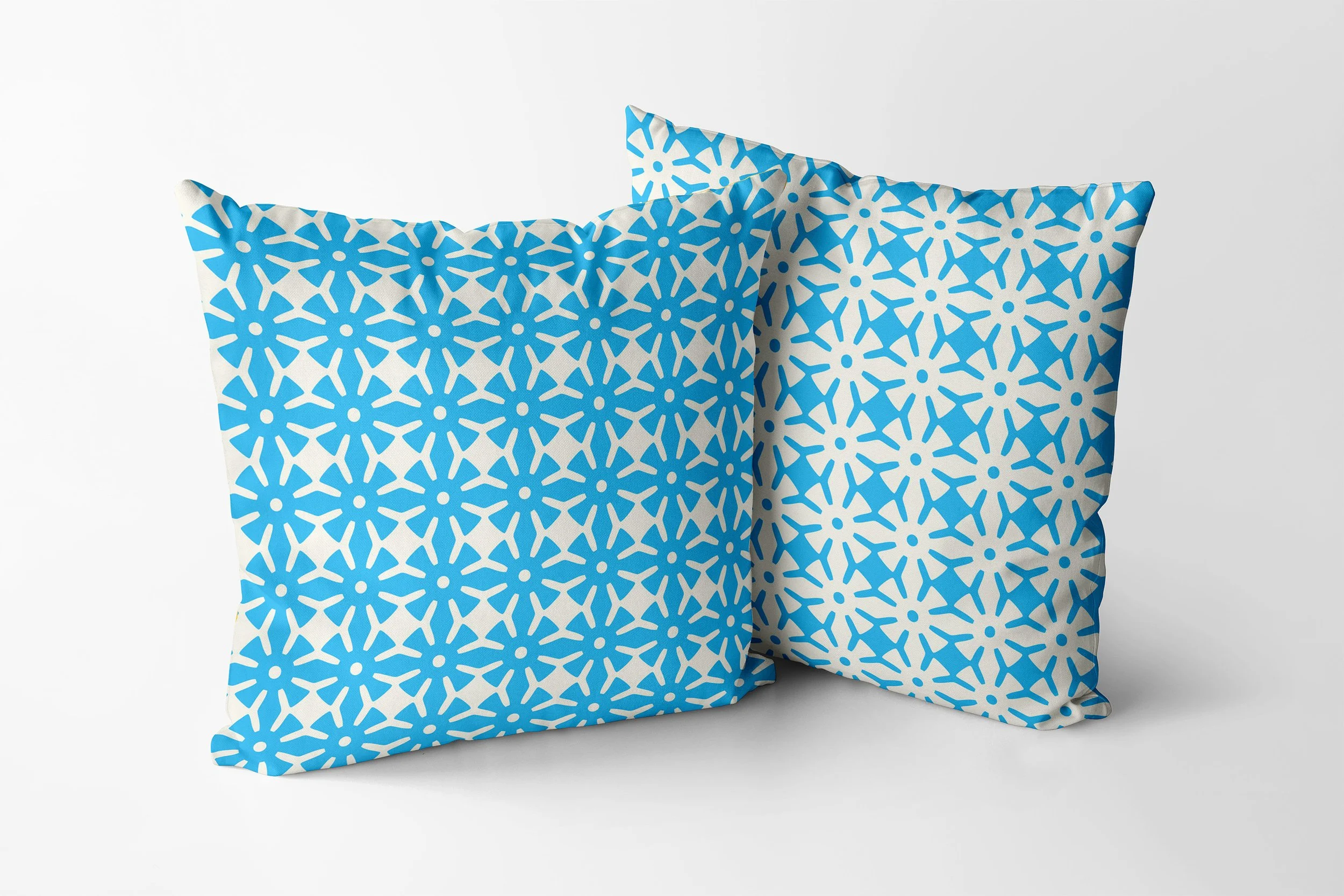 Ananse Ntontan cushions in aqua and eggshell.