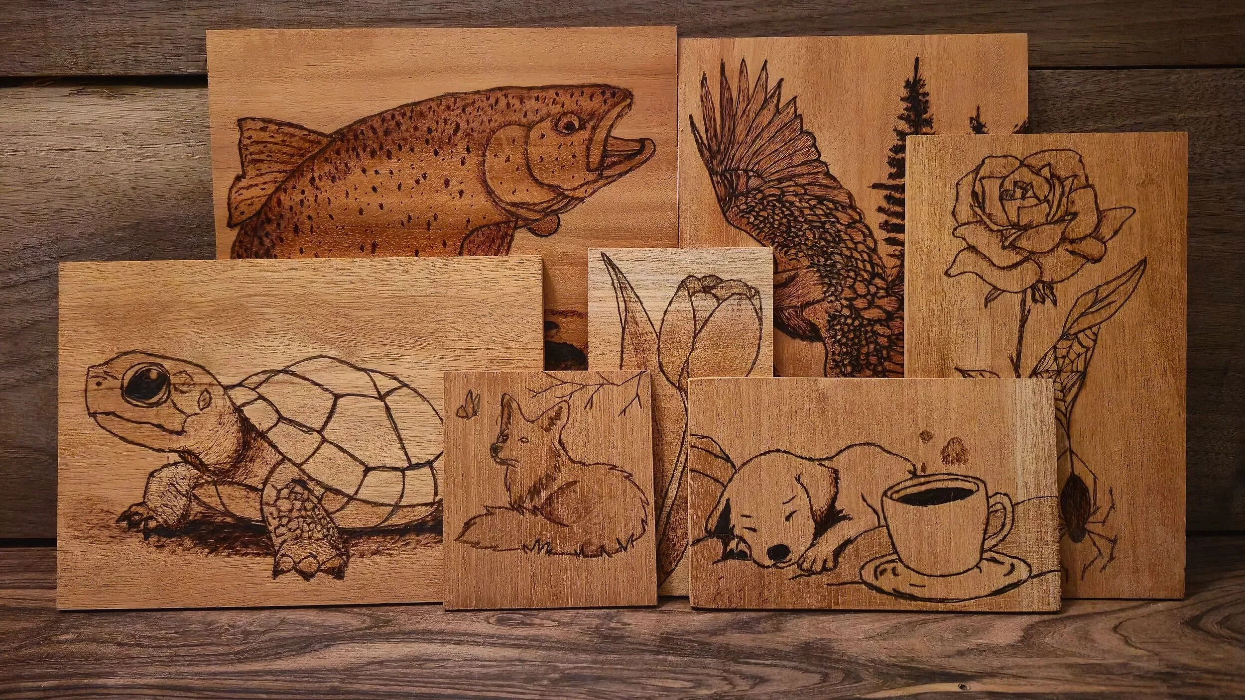 Collection of wood burnings such as animals and flowers.