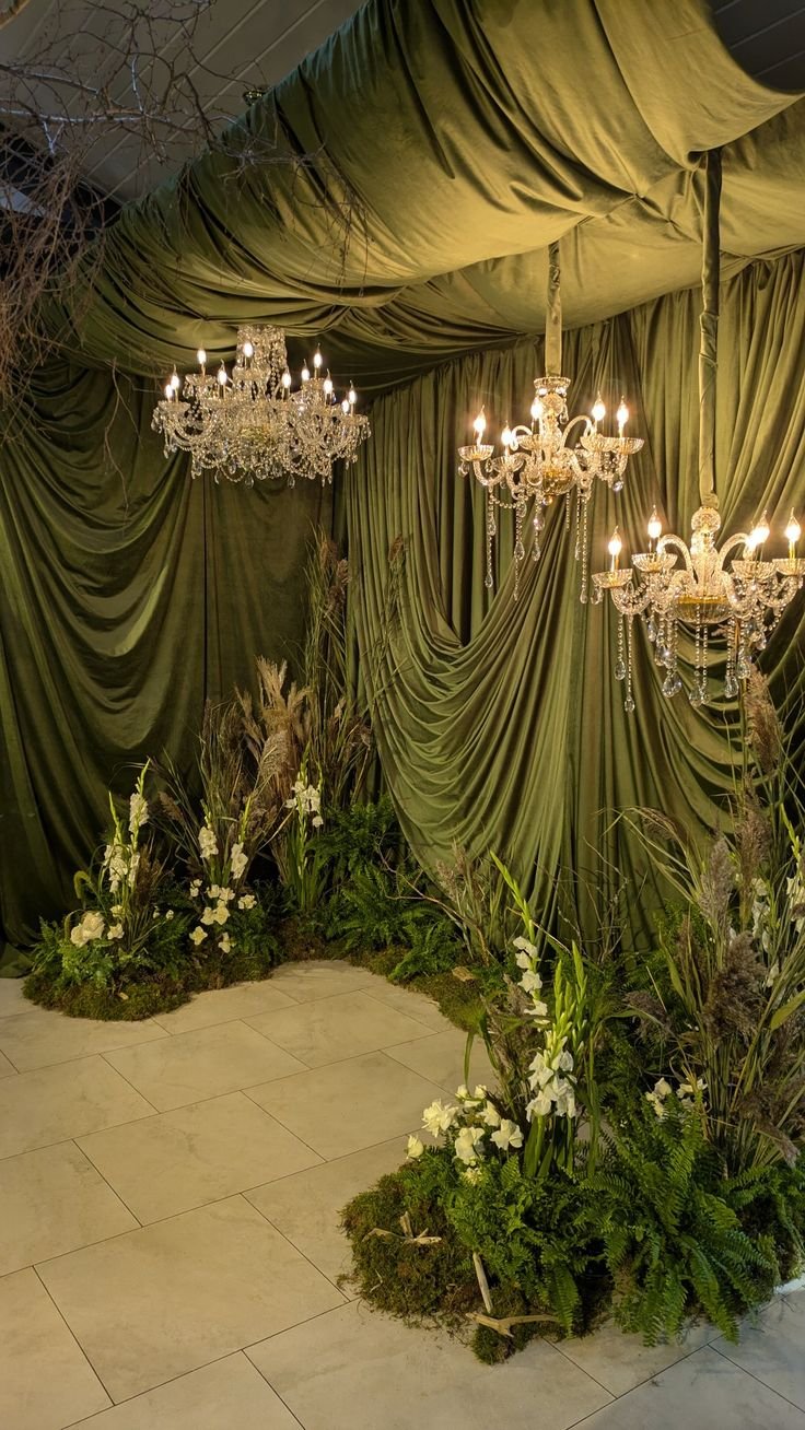 Studio-style wedding photo booth framed by dramatic fabric draping