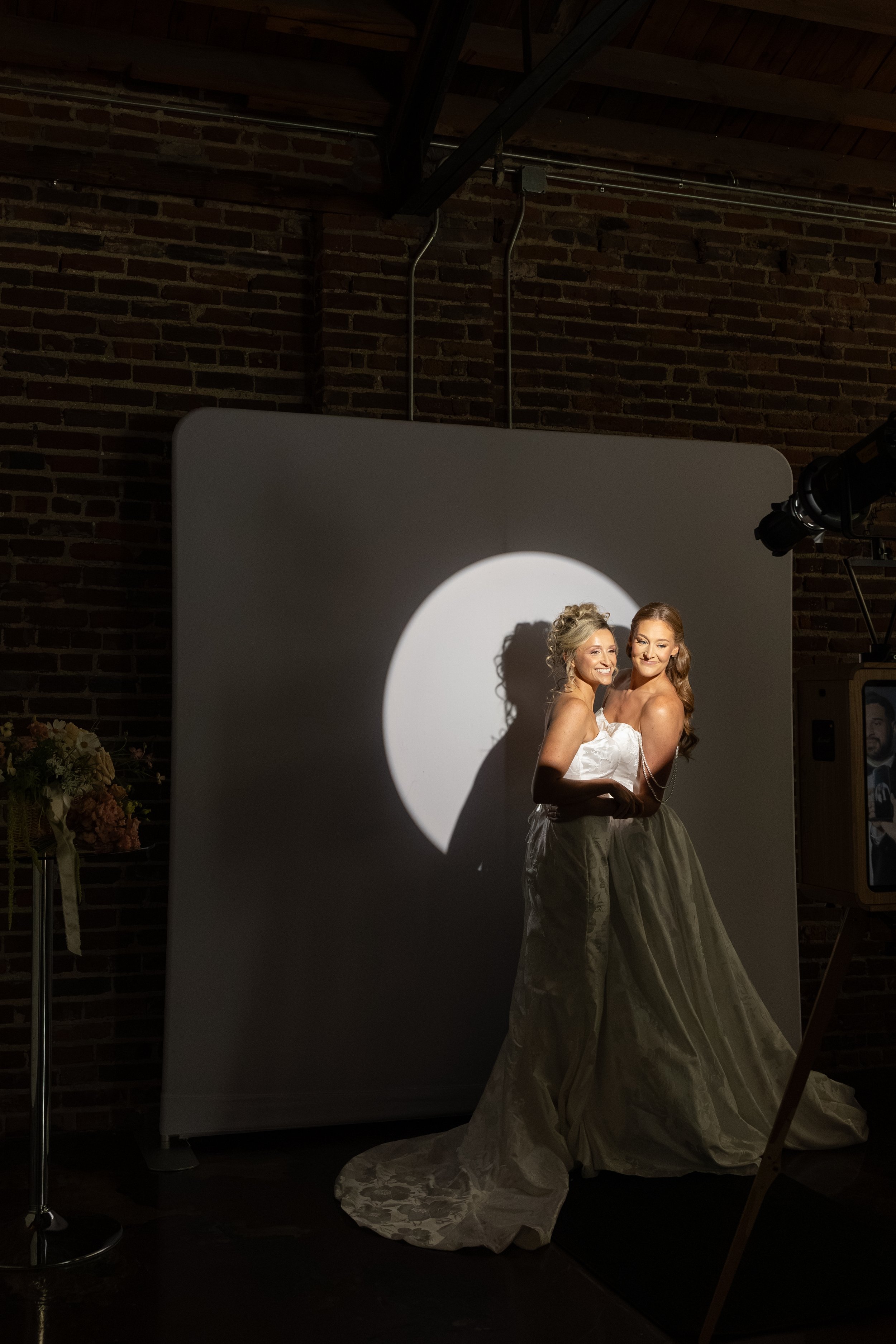 Spotlight Photo Booth at The Guild Kansas City with elegant couple posing against dramatic circular lighting backdrop.